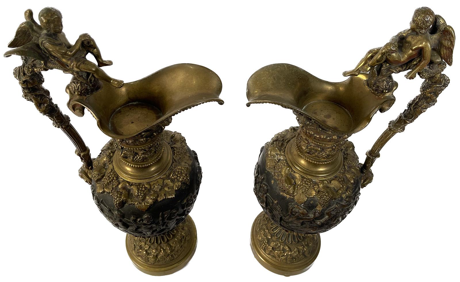 A pair of 19th century bronze ewers with figures.

Dimensions: 21
