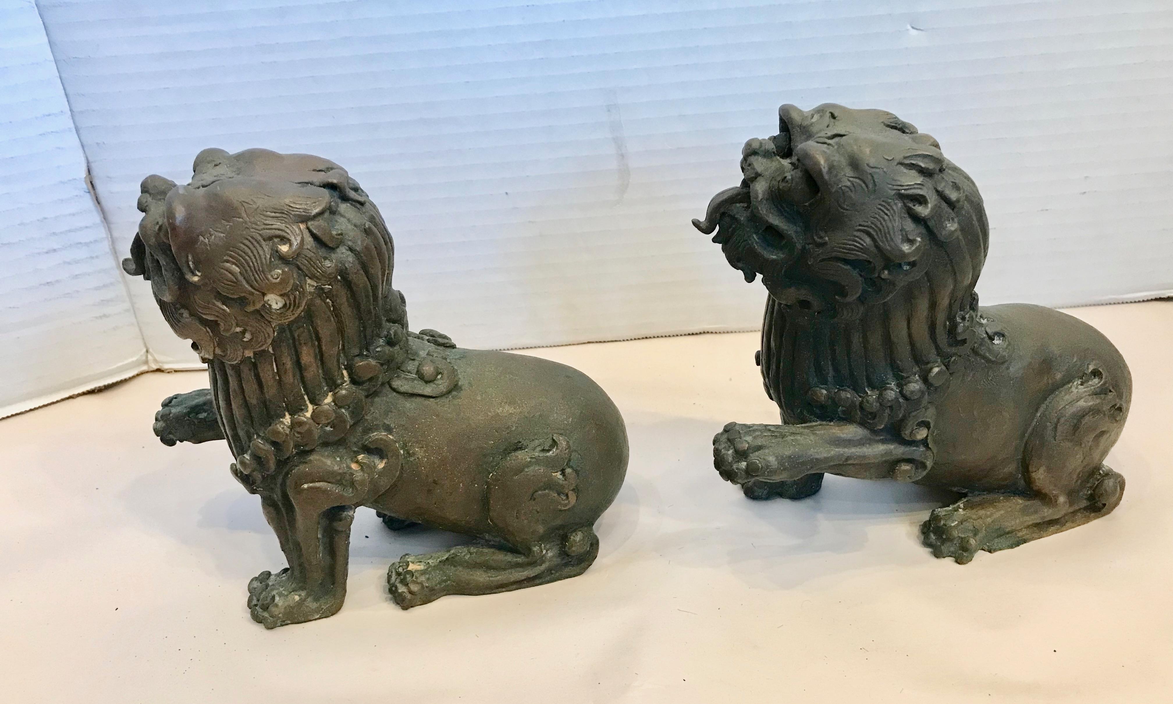 A proper pair - right and left facing. The bronzes have expressive faces
with protruding tongues and are posed with paws raised to indicate 
that they are at attention.
An outstanding and unusual pair.