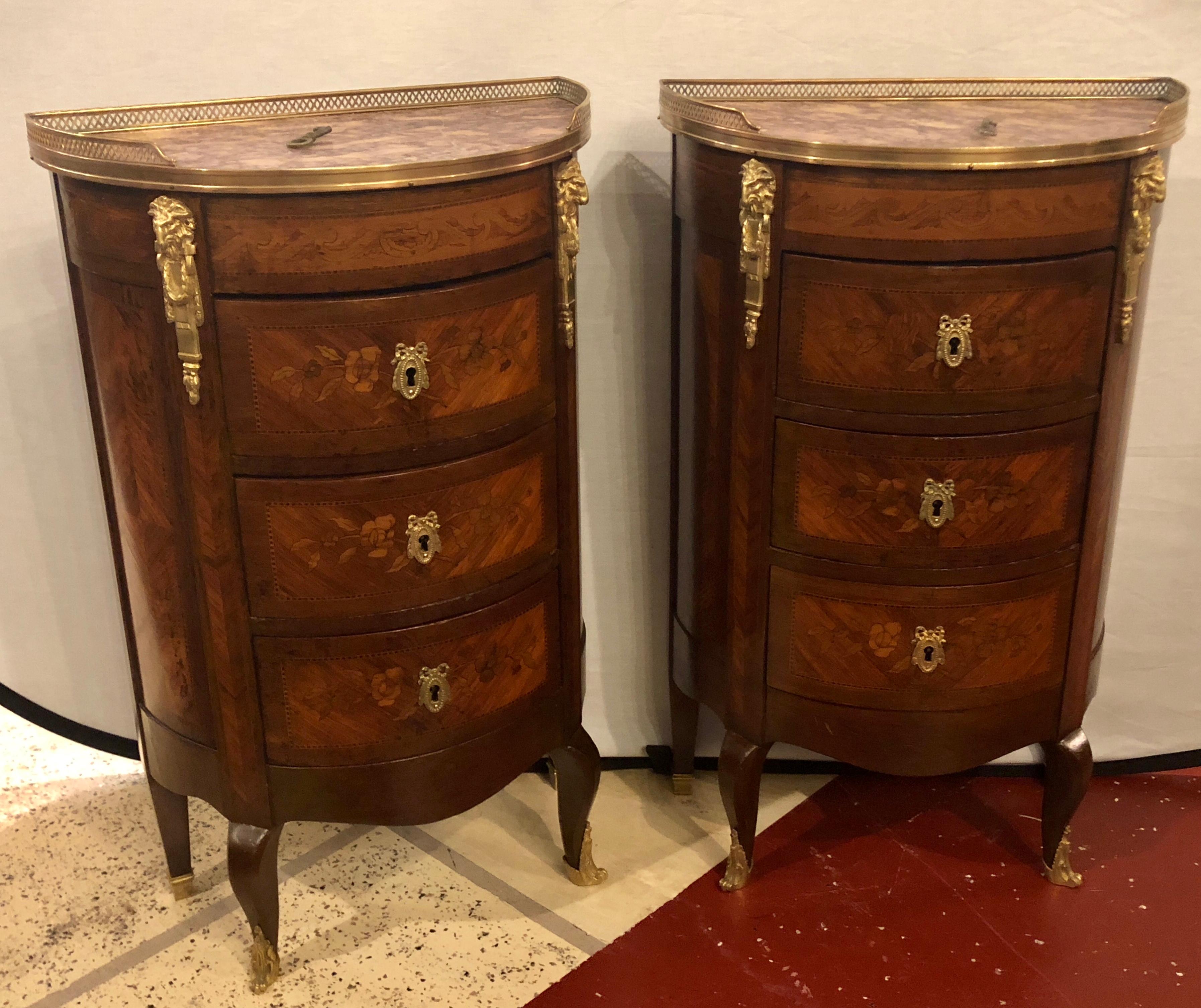 A pair of 19th century bronze mounted demilune end tables or nightstands. Fine demilune form with bronze galleried marble tops on floral inlaid fronts.
1 drawer missing an interior lock.

hxax.