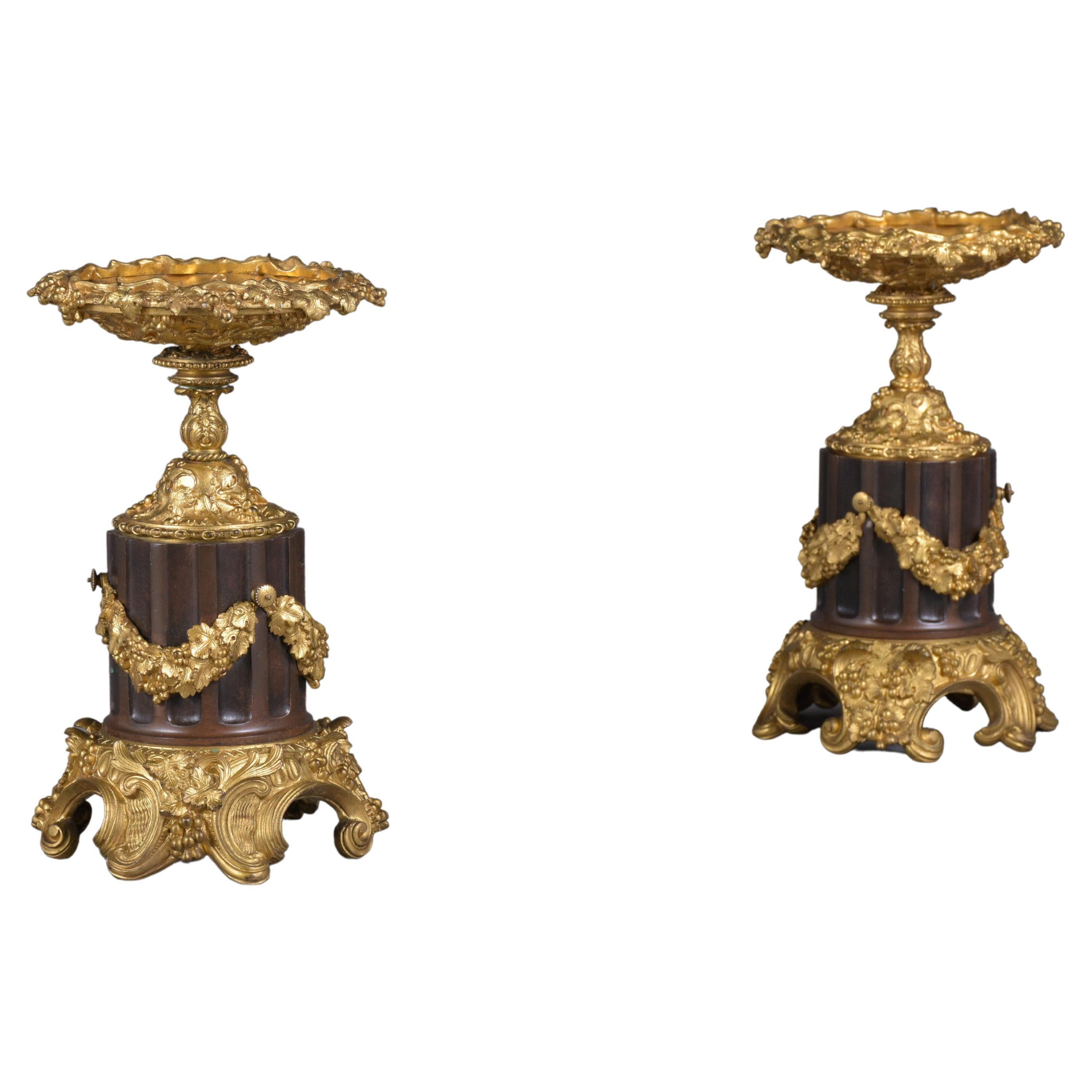 Step into the world of classical elegance with our exquisite pair of Early 19th-century French Urns, masterpieces of craftsmanship and historical beauty. These antique cassolettes, crafted from bronzed material, have been professionally restored by