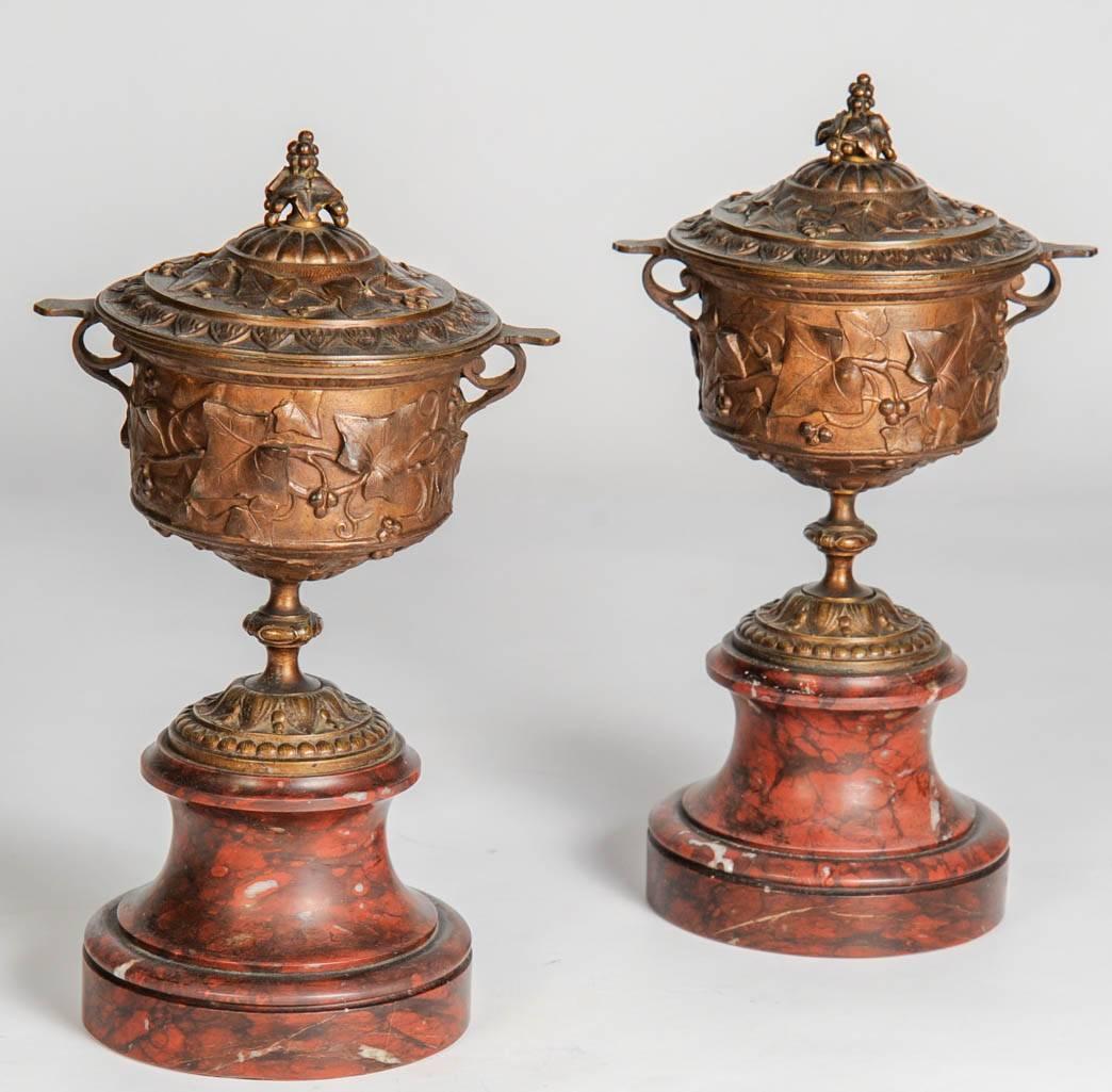 Neo-classic roman empire style bronze urns on marble base.