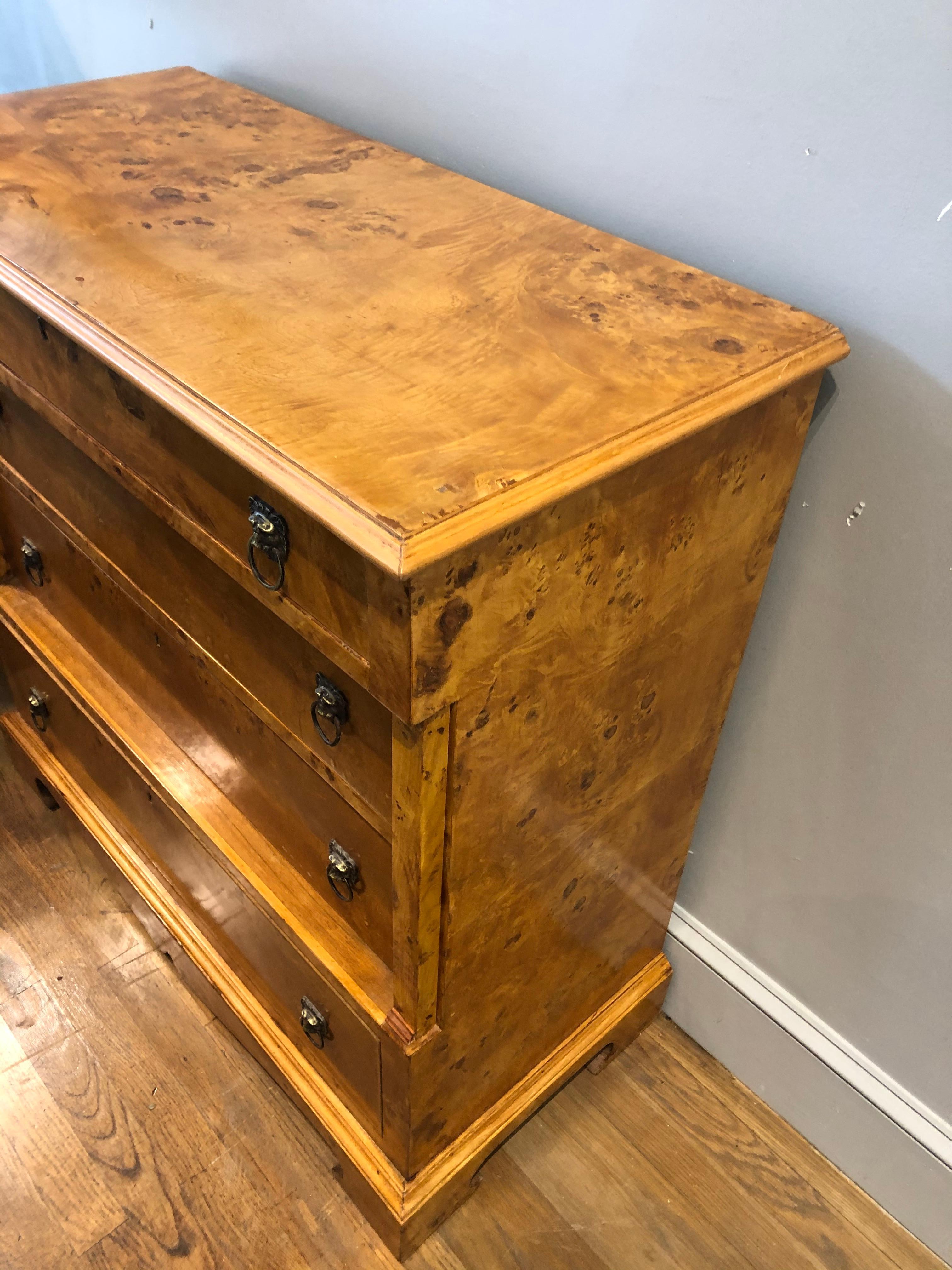 Fine pair of late 19th century Biedermeier chest of drawers. Made of highly figured “bookmatched” burled ash. Good proportions and unusual form with four drawers over decorative bracket feet. Made in Germany, circa 1880.