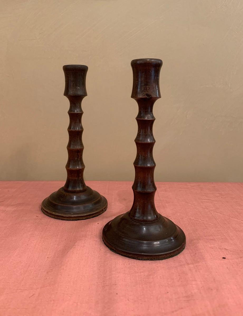A pair of French 19th century ebonized oak candlesticks. Skillfully turned in a faux bamboe.