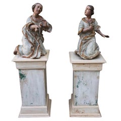 Paire d'anges sculptés sur piédestaux du 19ème siècle