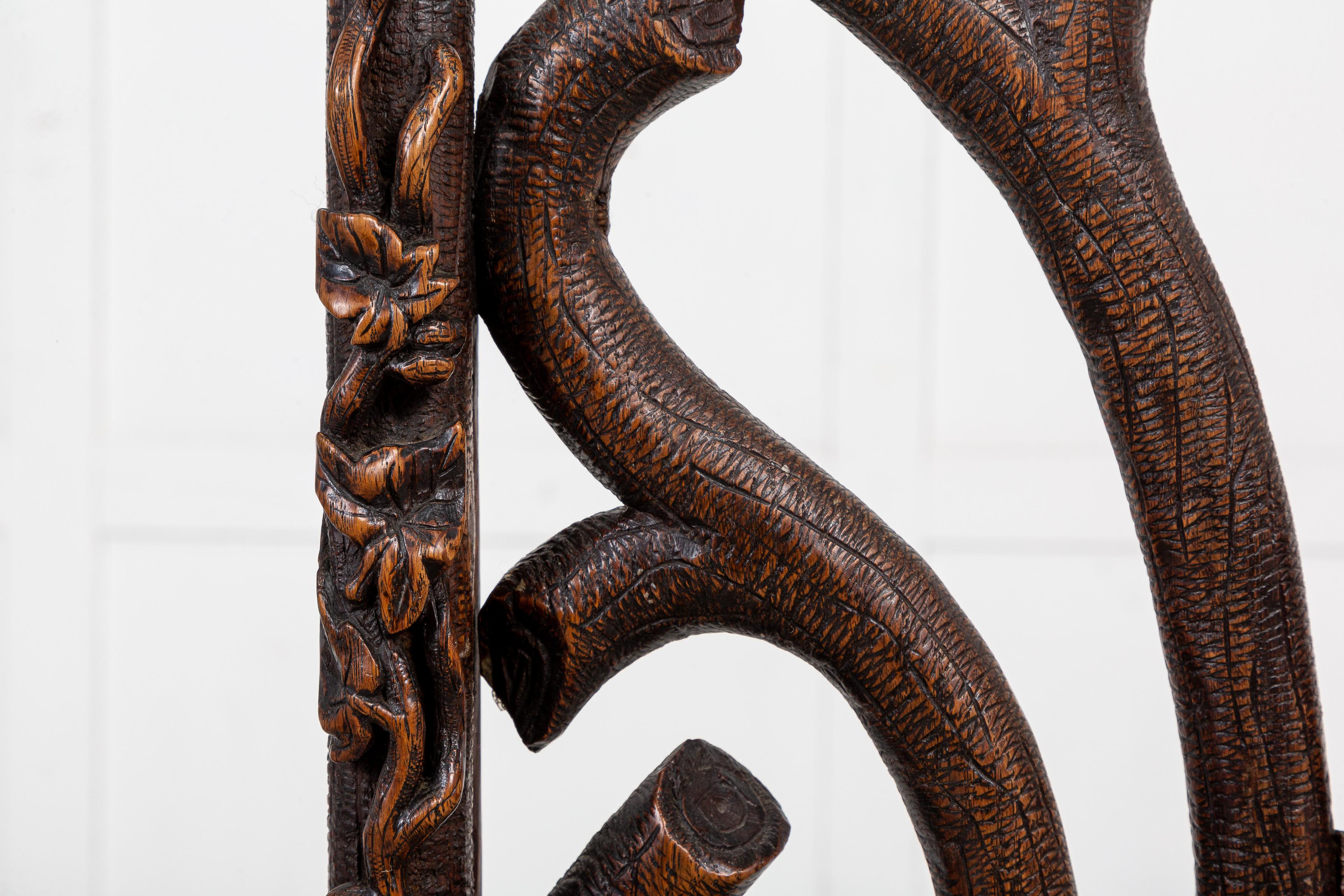 Black Forest Pair of 19th Century Carved Linden Wood Chairs For Sale