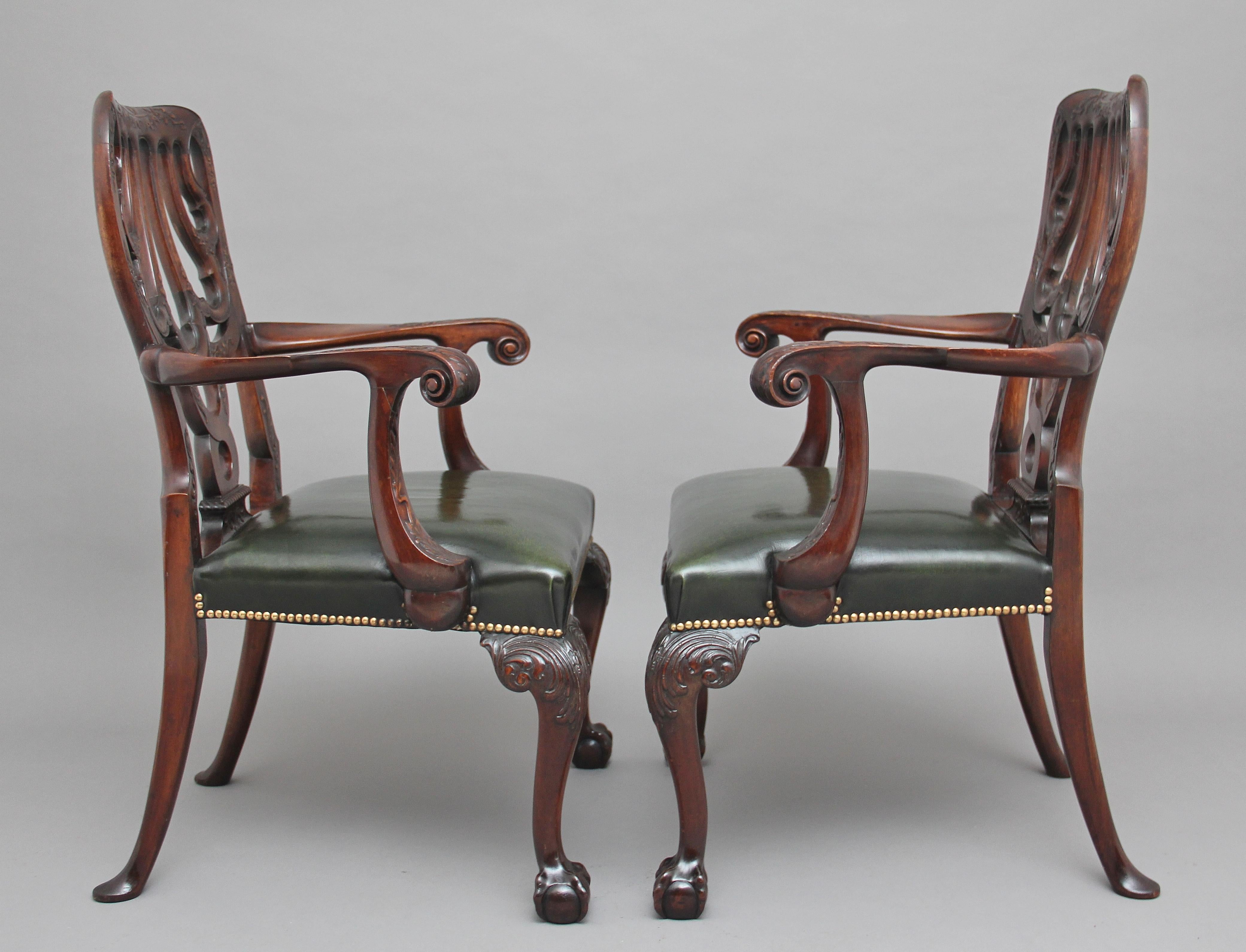 A pair of 19th century carved mahogany armchairs in the Chippendale style, superb quality and lovely dense timber, the supports carved with flower foliage, at the centre is a lovely shaped and carved back splat, the shaped curved arms terminating