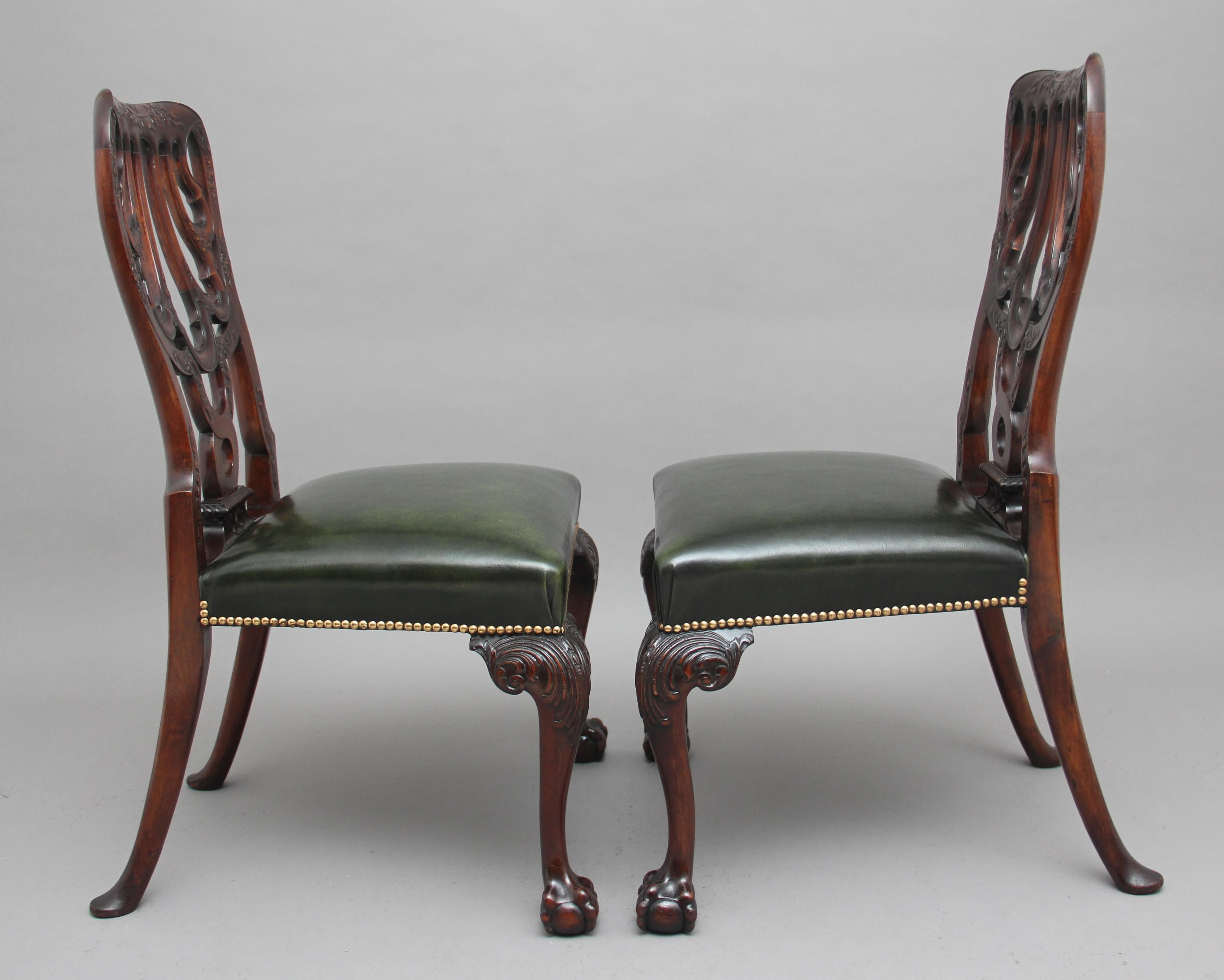 A pair of 19th century carved mahogany side chairs in the Chippendale style, superb quality and lovely dense timber, the carved and shaped back of unique design, the seat having been recently re-upholstered in a green leather with brass stud