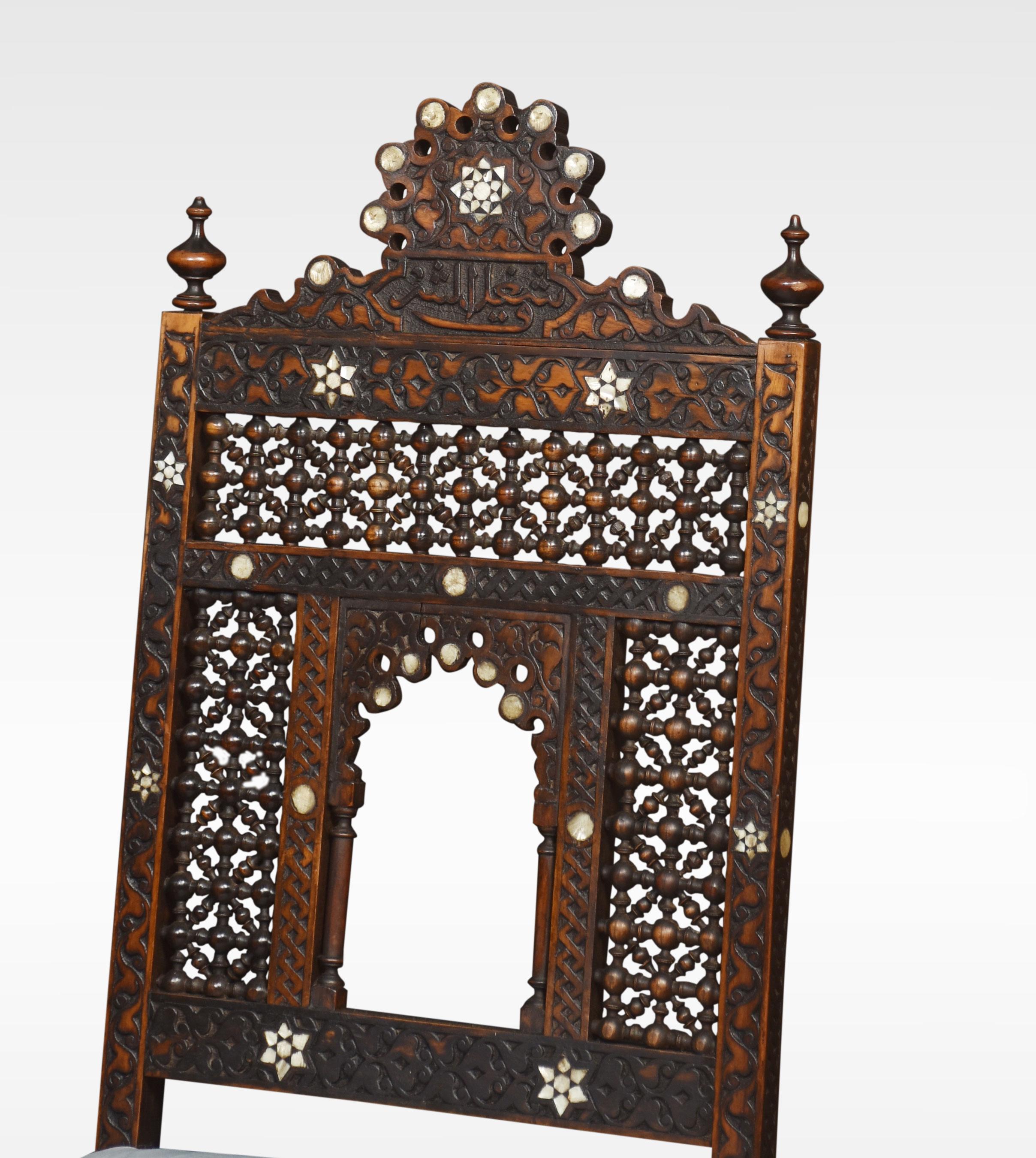 Pair of 19th century carved Moorish hardwood chairs, profusely carved throughout with mother of pearl inlay and Islamic carved inscription to the back rail, above the upholstered removable seat to a carved skirting block. All raised up on bun