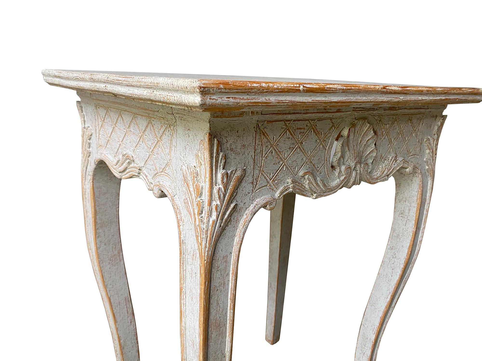 This decorative pair of 19th century tables feature a carved decorative freeze with diamond and shell design, and cabriolet legs with acanthus leaf decoration.