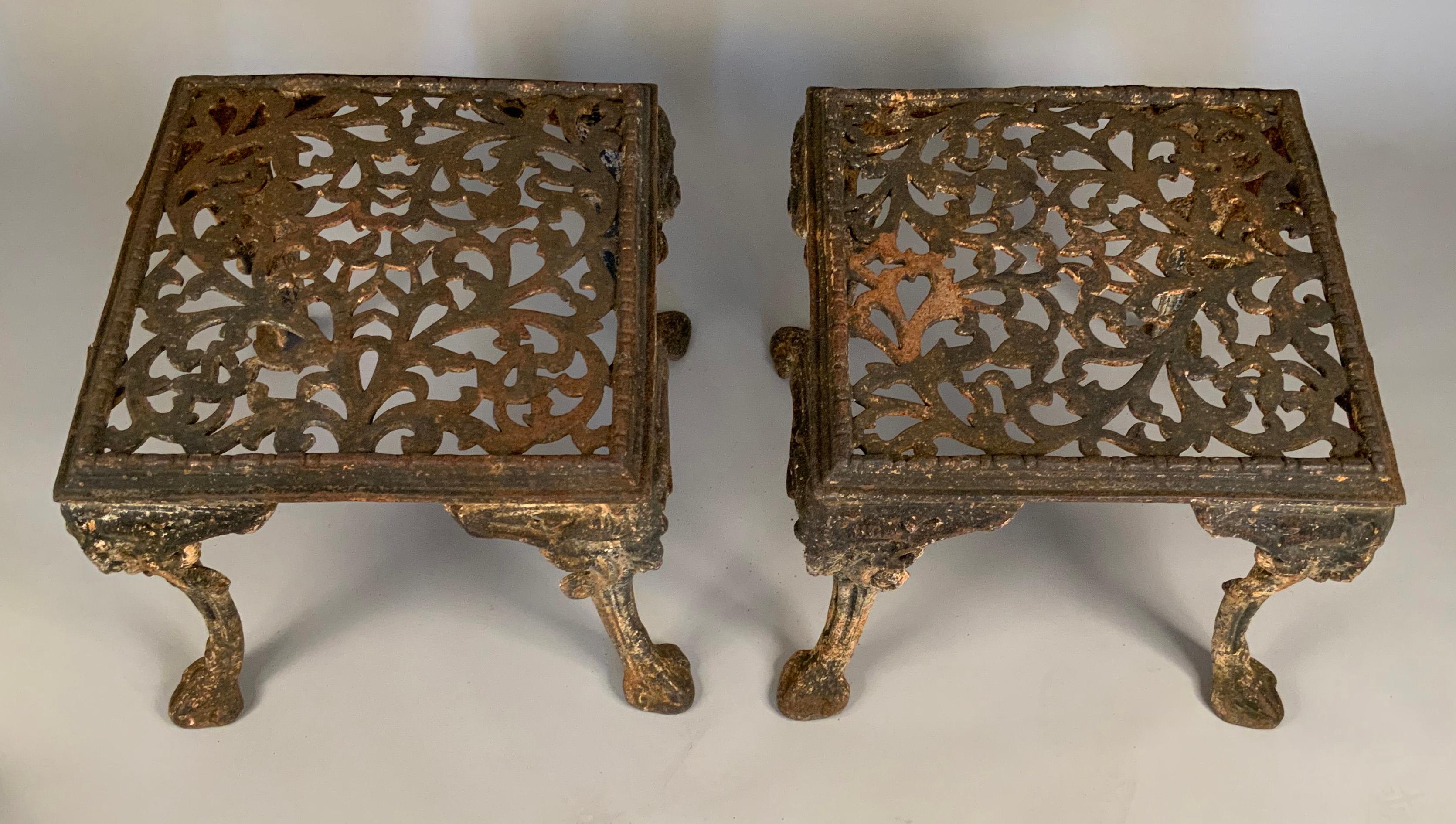 A very handsome pair of late 19th century cast iron garden benches or tables, with filigree tops and legs in the form of Satyrs. Very heavy and stable and well made, with beautiful old patina.