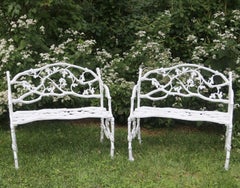 Pair of 19th-century cast-iron twig seats marked by maker
