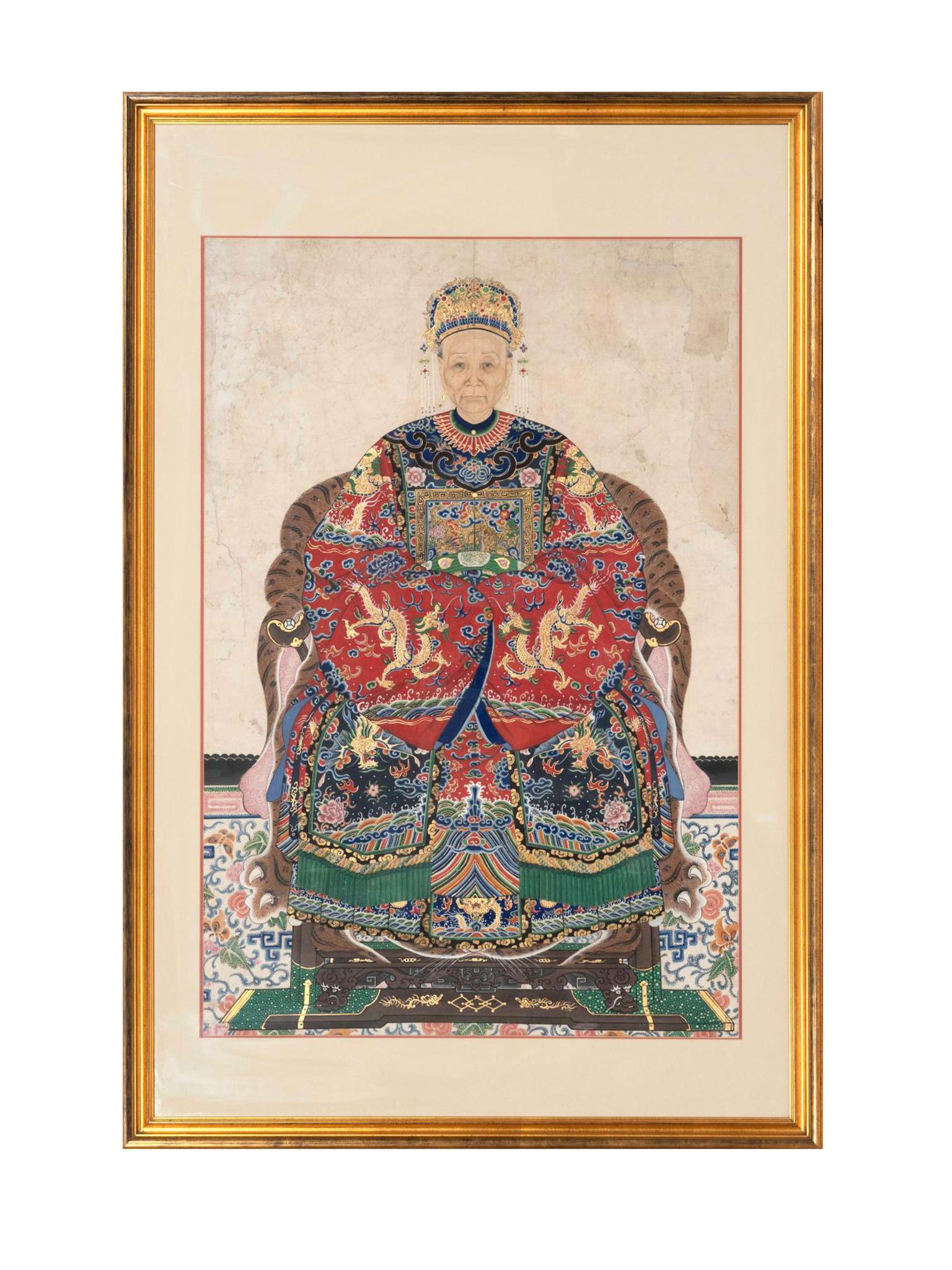 A pair of Chinese ancestral portraits, painted in the 19th century during the Qing Dynasty era. The portraits are rendered in watercolors and gouaches on paper. Each seated figure is dressed in richly hued robes. The Mandarin duck insignia adorns