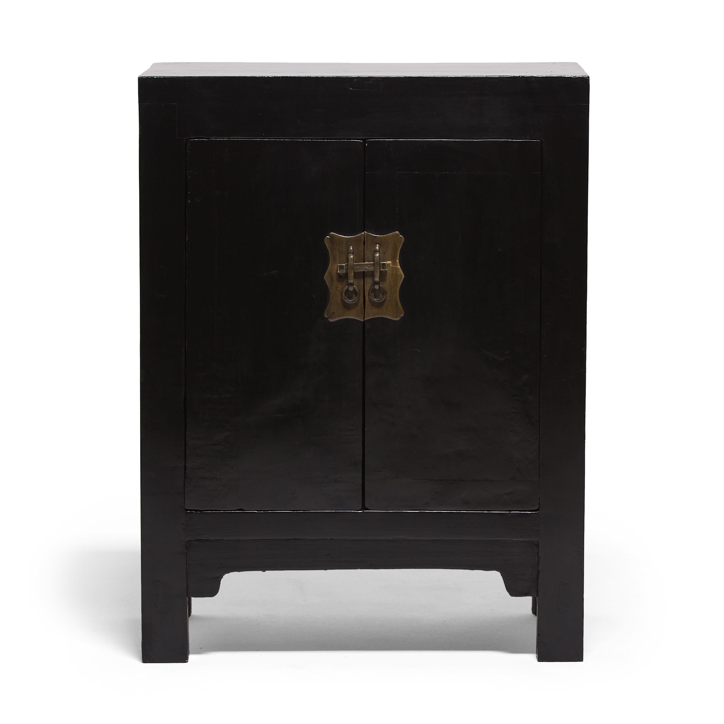 Perfecting line and proportion, the simple design of this pair of locking cabinets celebrates the restraint of Classic Chinese furniture forms. Used for storage in a Qing-dynasty home, the pair of small square-corner cabinets would have been placed