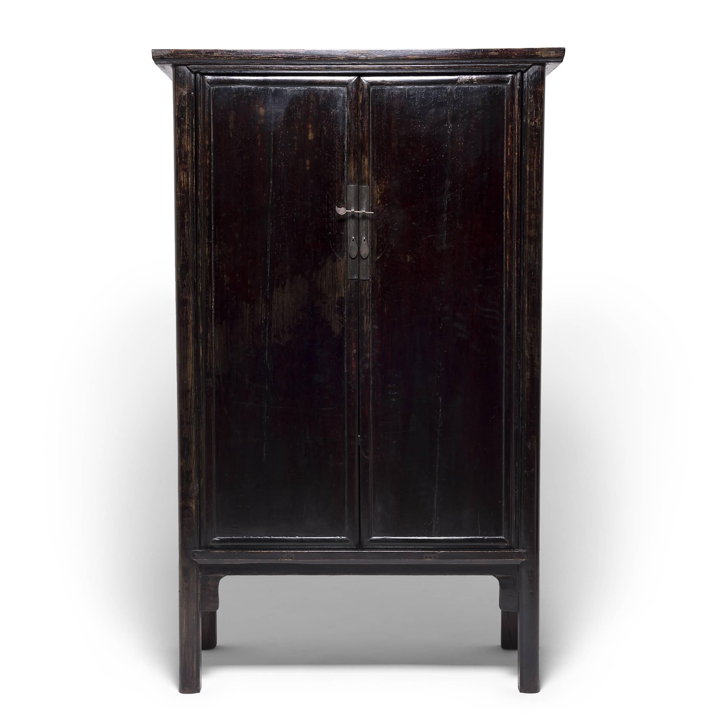 Created in China's Shanxi province, these striking, early 19th century cabinets take their name from their elegant, rounded wood frames. Austere in their simplicity, the cabinets' rich lacquer was hand applied, layer upon layer, to achieve a deep