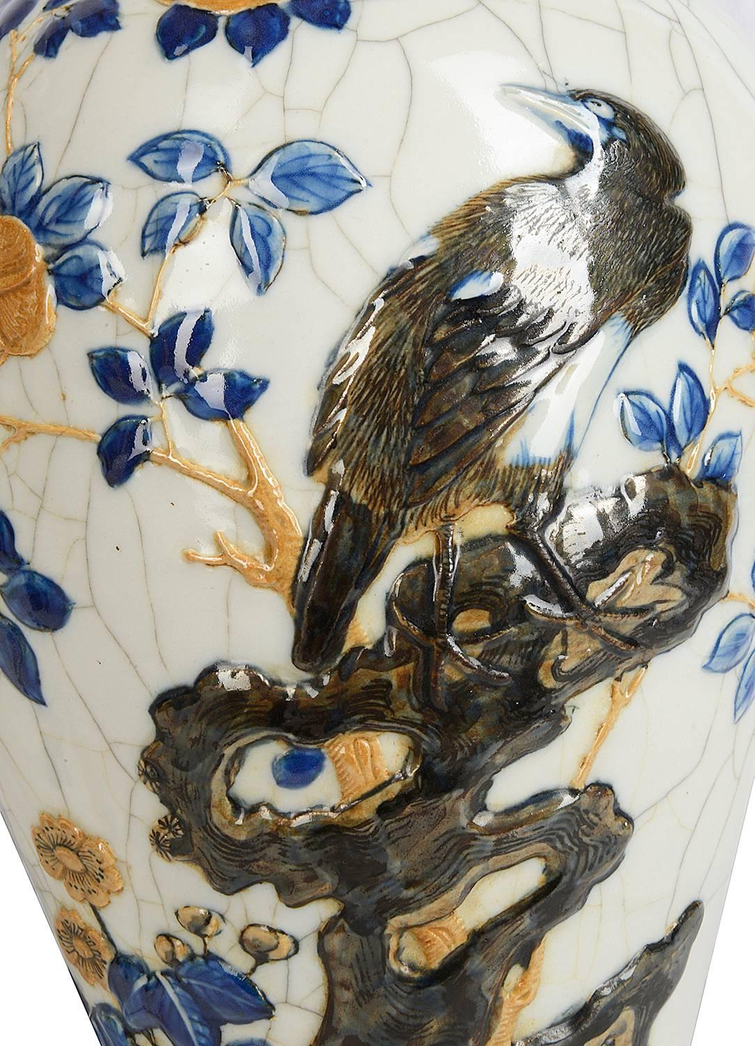 A pair of late 19th century Chinese blue and white crackleware vases, each depicting birds on a branch with flowers and leaf decoration.