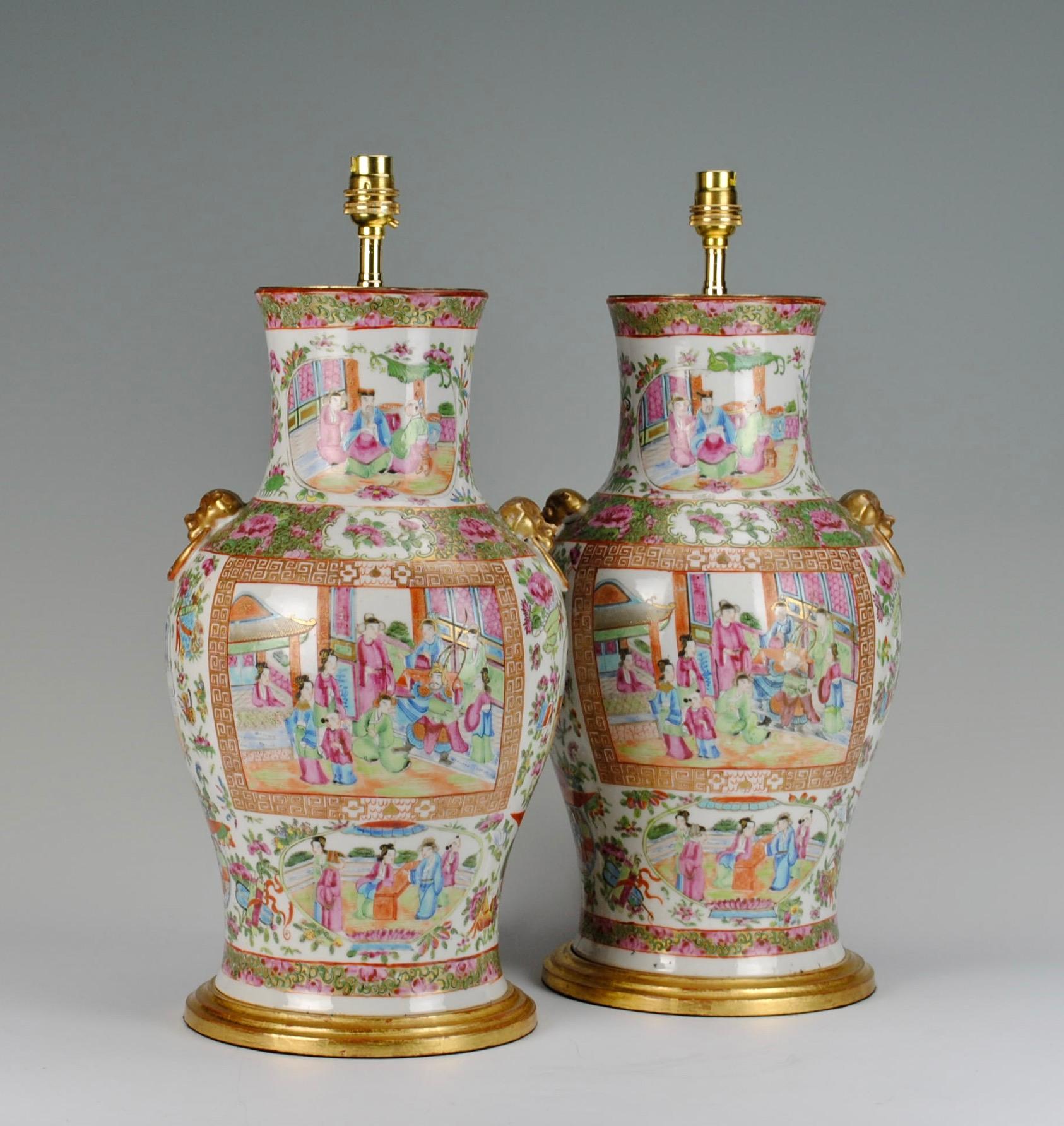 A fine pair of Chinese late 19th century Canton medallion vases, decorated in the Famille rose palette. Now mounted as lamps with hand gilded turned bases.

Height of vases 16 1/2 in (42 cm) including giltwood bases, excluding electrical fitments