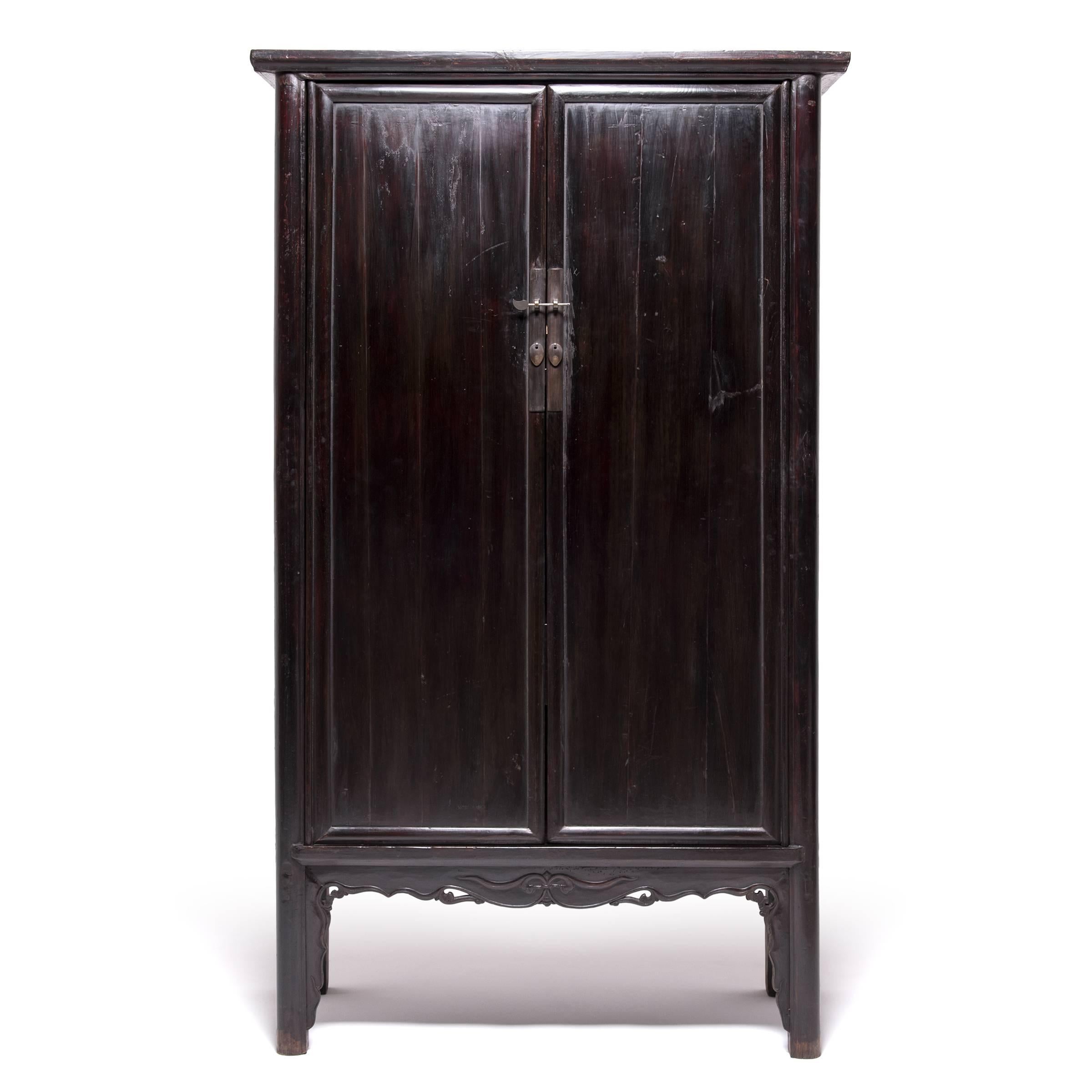 Appealing to the refined tastes of a learned scholar, this pair of 19th century cabinets strikes the perfect balance between austere beauty and artful decoration. Handcrafted of northern elmwood and laboriously layered with black lacquer, these