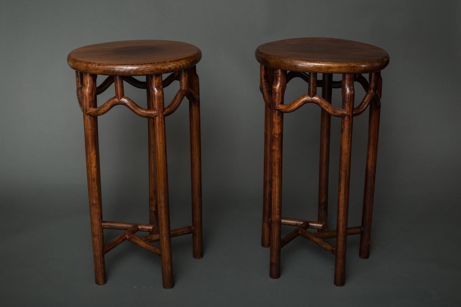 A pair of round pedestals made of elm wood with a beautiful, old patina. 