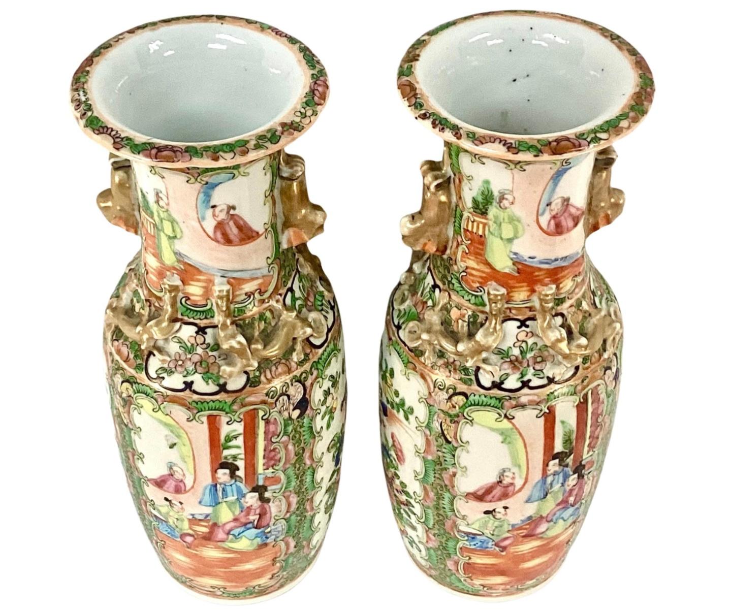 Pair of 19th century Chinese Export famille rose medallion porcelain vases. Colors include pink, blue and green on white background with gold trim. Striking pair of vases with bright vivid colors.