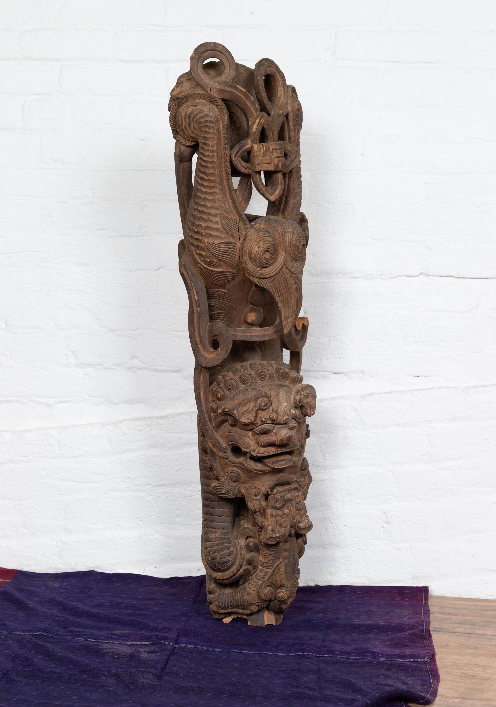 A pair of 18th or 19th century Chinese wooden carvings from a temple wall, depicting guardian lions. Born in Imperial China, each of this pair of temple carvings depicts a guardian lion boasting exquisite scrolled accents and a striking expression.