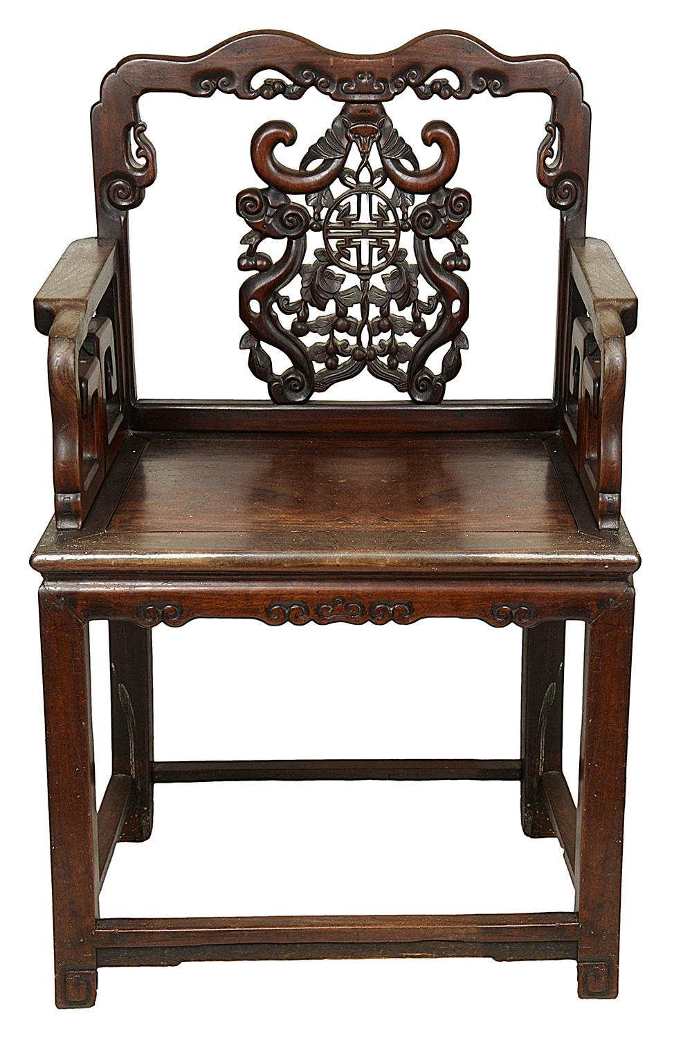 A good quality pair of 19th century Chinese hardwood arm chairs, each with carved bats above a motif and surrounded by cherries and leaves, raised on square section legs united by stretchers.
