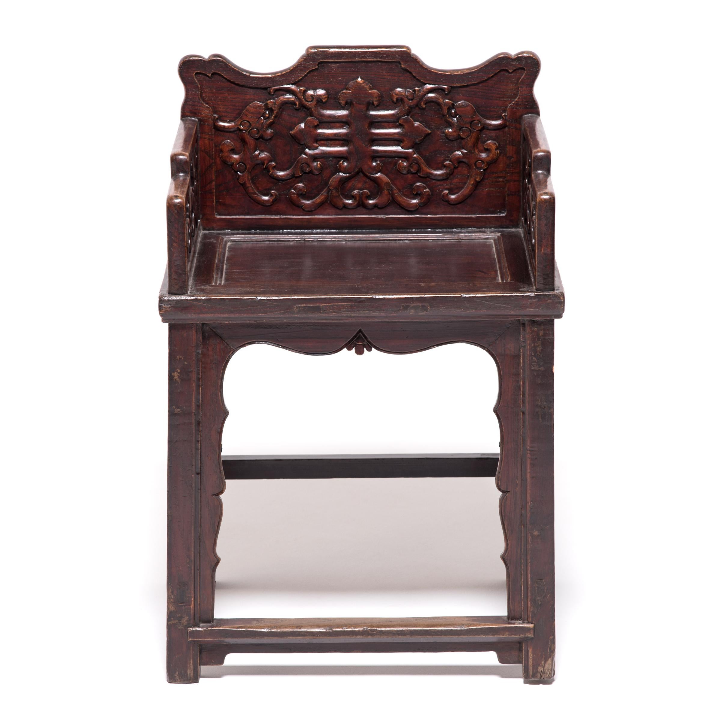 These exquisitely carved, low-back armchairs are utterly unique in silhouette and decoration. Constructed in the Taishiyi style, an ancient design intended for imperial palaces, the chairs play with tradition with scalloped aprons and stepped arm