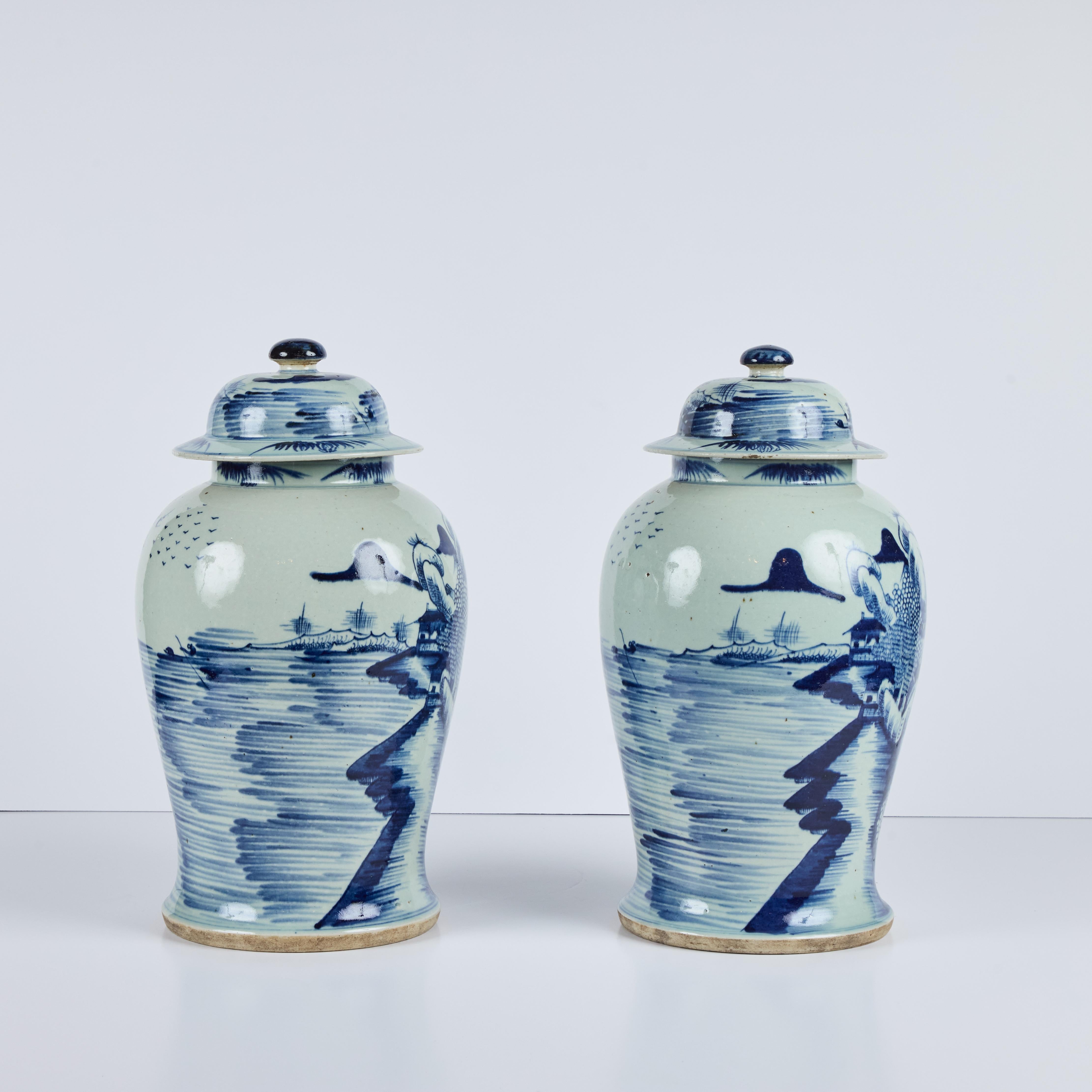 A charming pair of Chinese porcelain lidded jars with hand-painted decoration of a village.