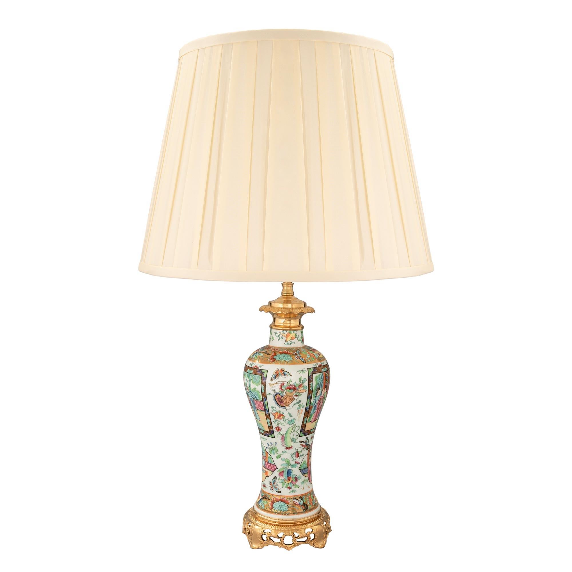 A beautiful pair of 19th century Chinese export porcelain lamps decorated with 19th century French Louis XVI st. ormolu mounts. Each lamp is raised by a beautiful pierced foliate ormolu base with a fine wrap around band. The elegantly shaped
