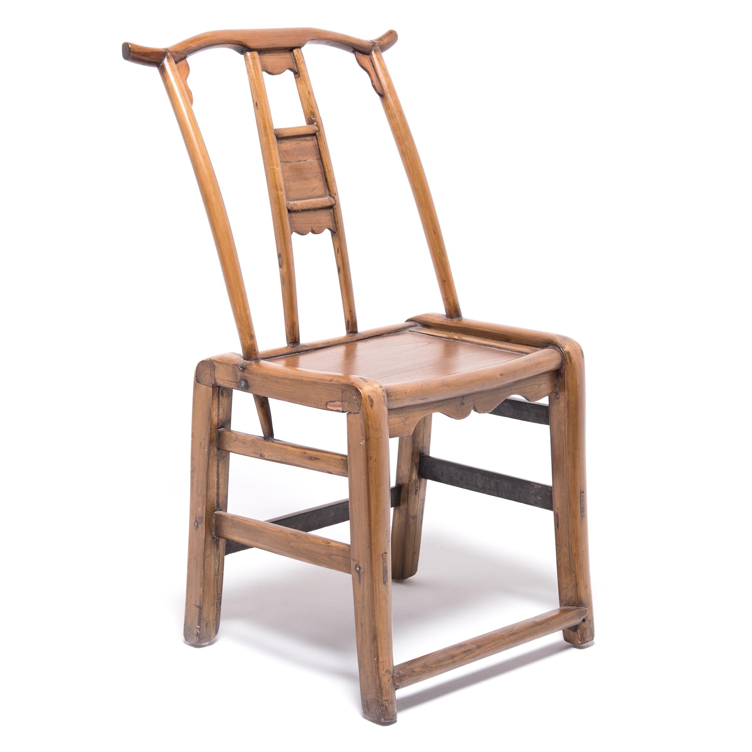 These 19th century cypress chairs with gently curved crest rails and undulating aprons were created by the age-old process of soaking, bending, and heating the wood to form it into the shape desired. The bent form legs wrap the top of the seat