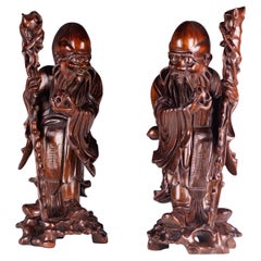 Paire de figurines d'immortels en bois dur de la dynastie chinoise Qing du 19e siècle