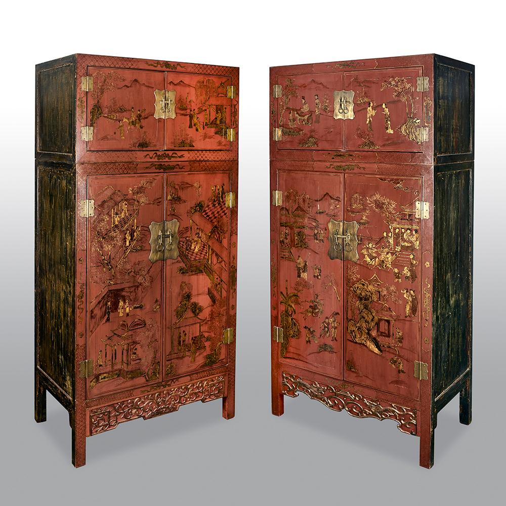 A fine matched pair of Qing period Chinese red gilt lacquered cabinets/bookcases of rectangular form, with two square panel doors to the upper section and two large rectangular panel doors to the lower section, each decorated with Chinese landscapes