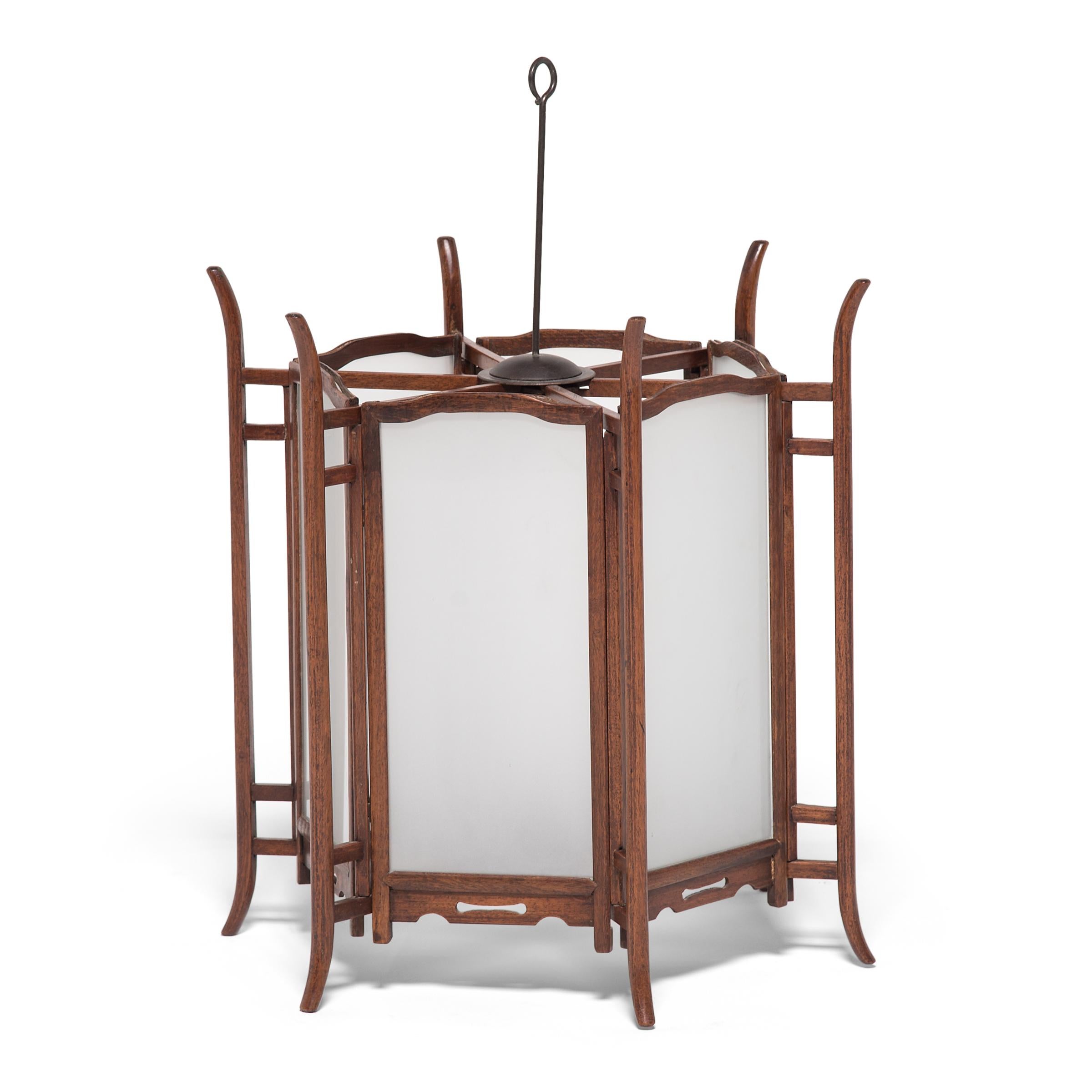 Elegantly constructed of thin pieces of fine hardwood, this pair of ornate 19th-century lanterns would have originally been lit with candles to illuminate a courtyard home in China's Shanxi province. Chinese lanterns have a history that goes back