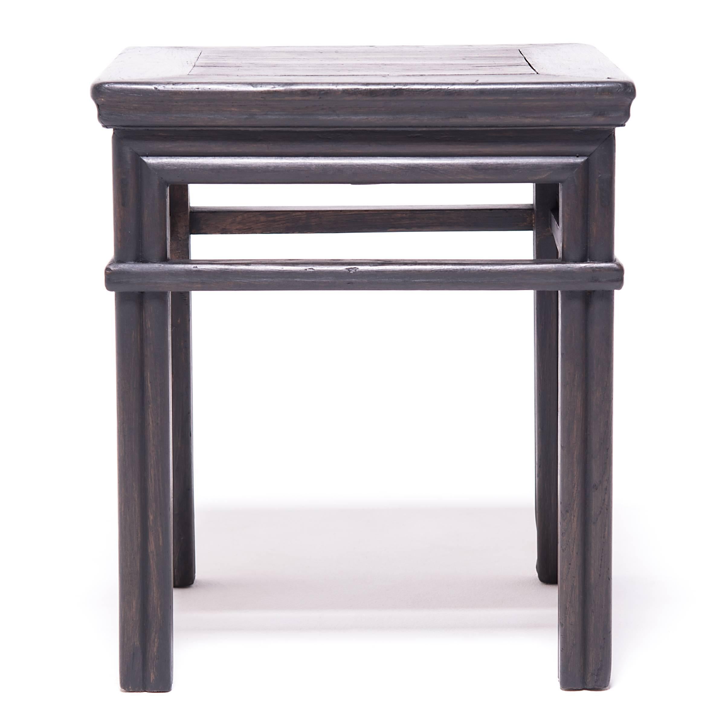 This form of square stool, or fang deng, was a versatile seating option and was pulled up for use at mealtimes or used outdoors in a courtyard or garden. The pair is expertly crafted of northern elm (yumu) with mortise-and-tenon joinery and a dark
