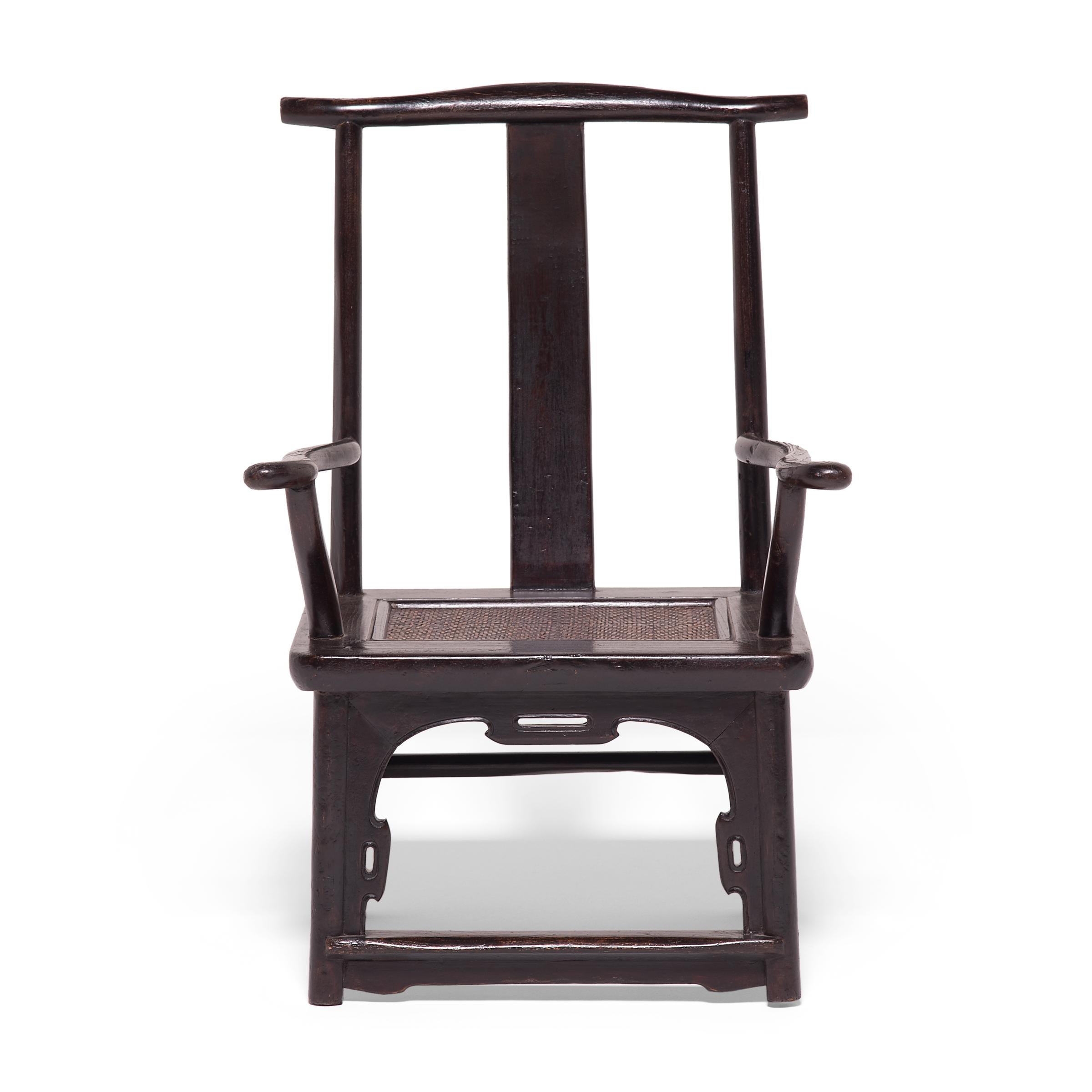 Unusual for its small scale, this pair of 19th century tall back chairs are diminutive updates on the classic yoke-back armchair popular since the Song dynasty. Also referred to as official’s hat chairs, the chair mimics the brimmed hats of