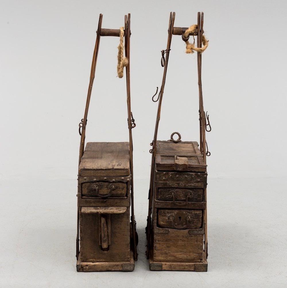 Two Chinese wooden storage boxes with handles and drawers, Qing dynasty, circa 19th century.