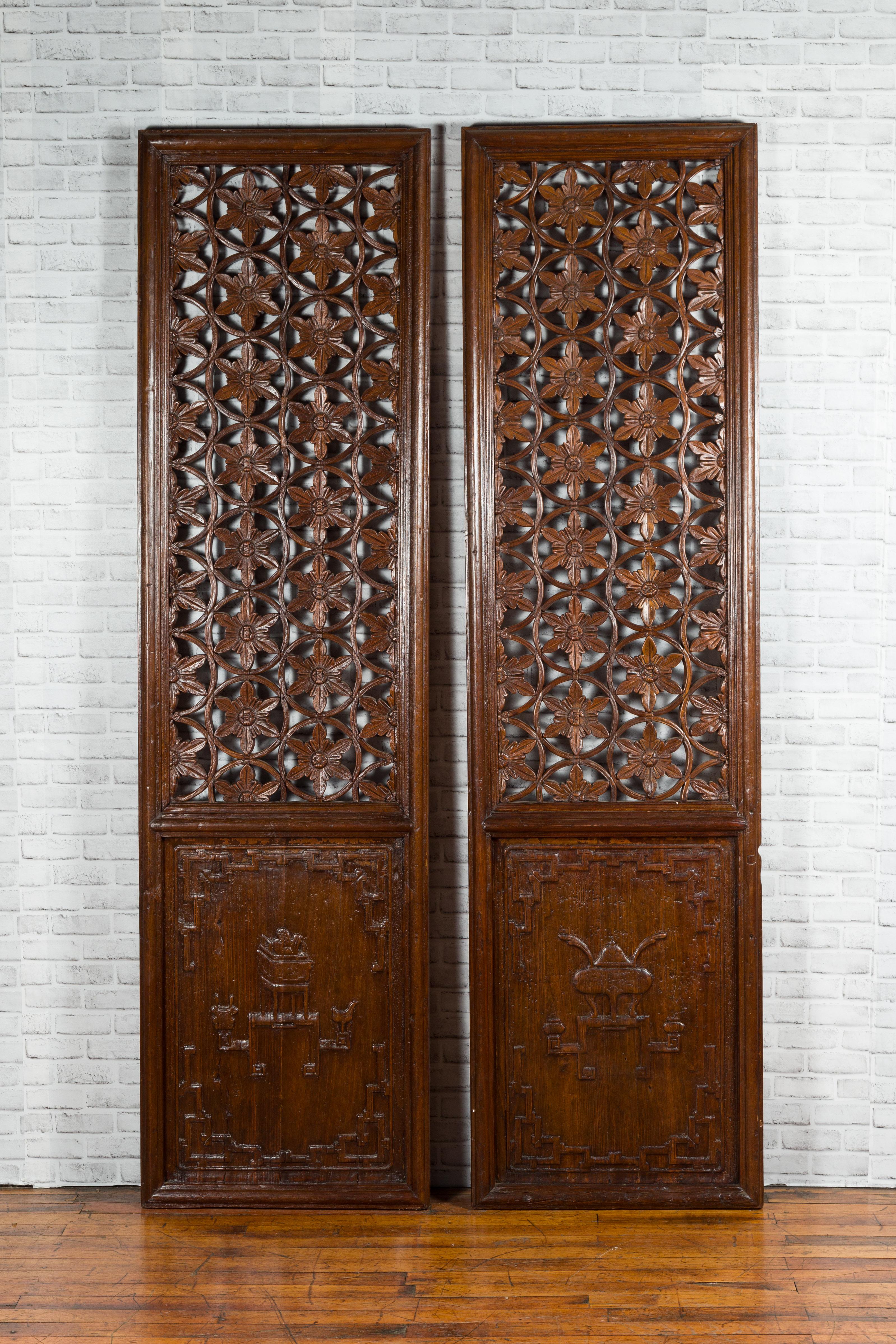 A pair of Chinese wooden panels from the 19th century, with floral motifs and carved objects. Created in China during the 19th century, each of this pair of wooden panels attracts our attention with its exquisite floral pierced decor adorning the
