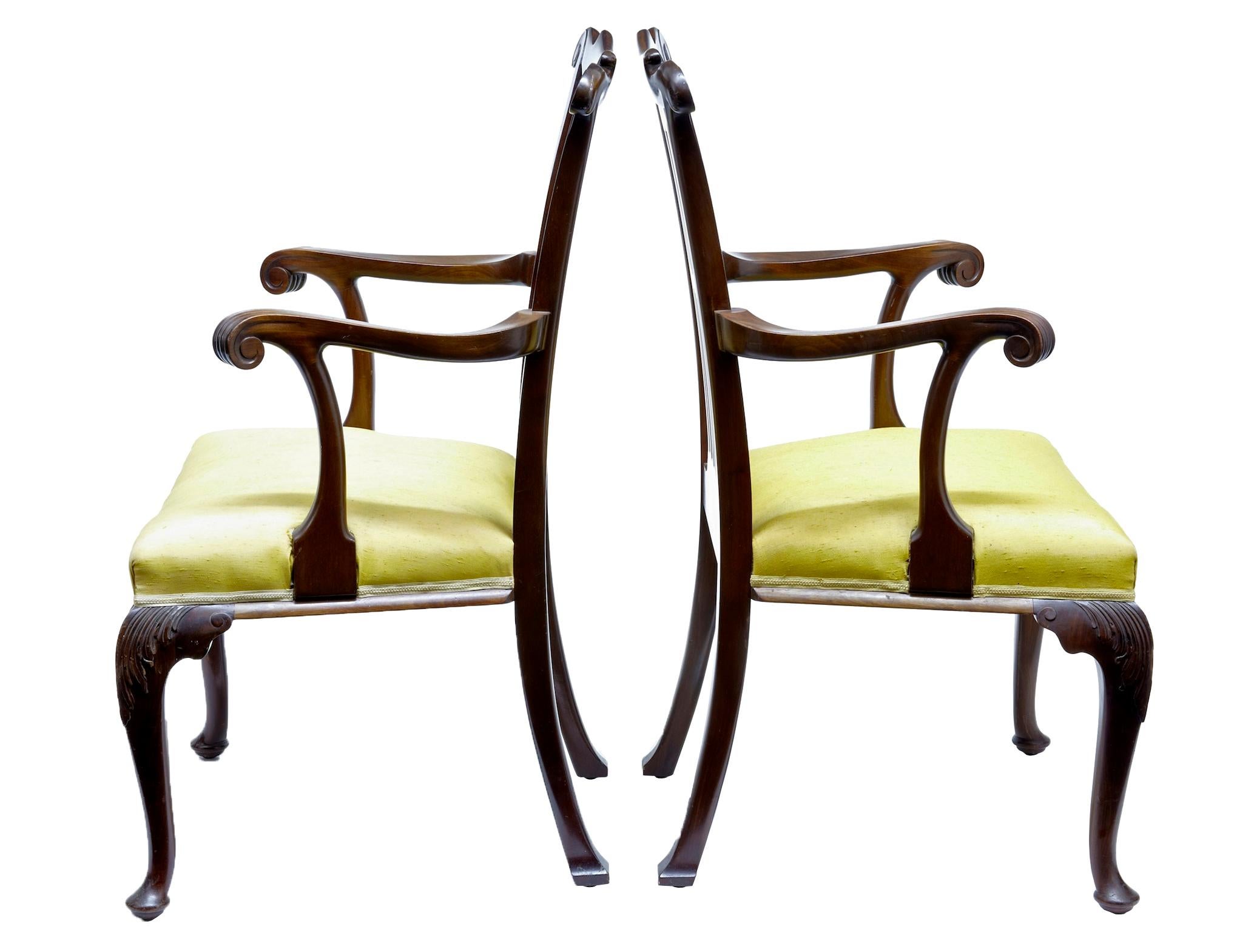 Elegant pair of mahogany armchairs strongly influenced by chippendale design, circa 1890.

Shaped backs with carved scrolling arms. Acanthus leaf detail to the knee, and carved rail. Standing on front pad foot.

Minor surface marks from