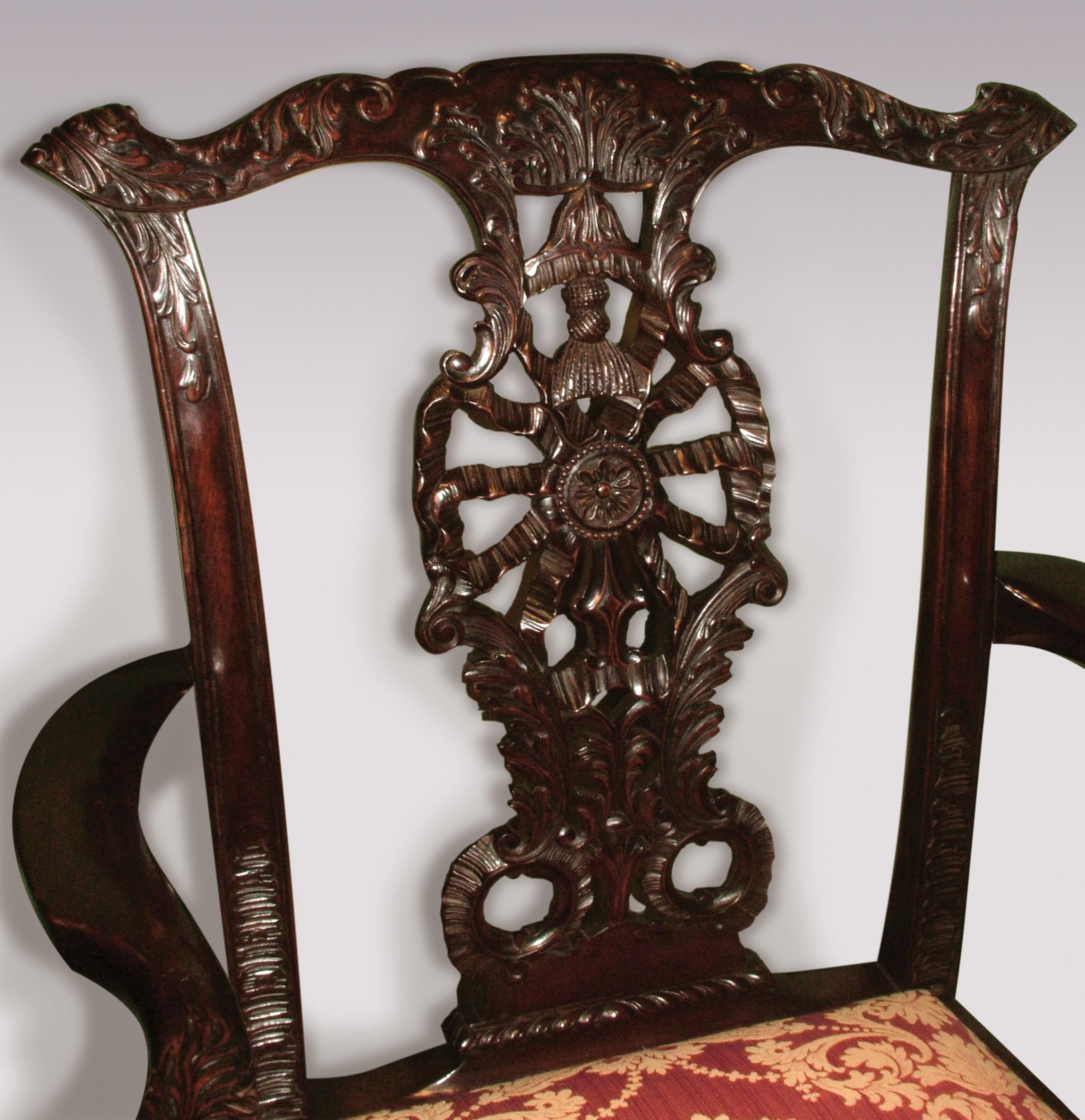 An imposing pair of 19th century Chippendale style mahogany armchairs having acanthus carved top rails above ribbon, tassel and acanthus splat with unusual bird carved arms fitted with drop in seats supported on carved cabriole legs ending on claw