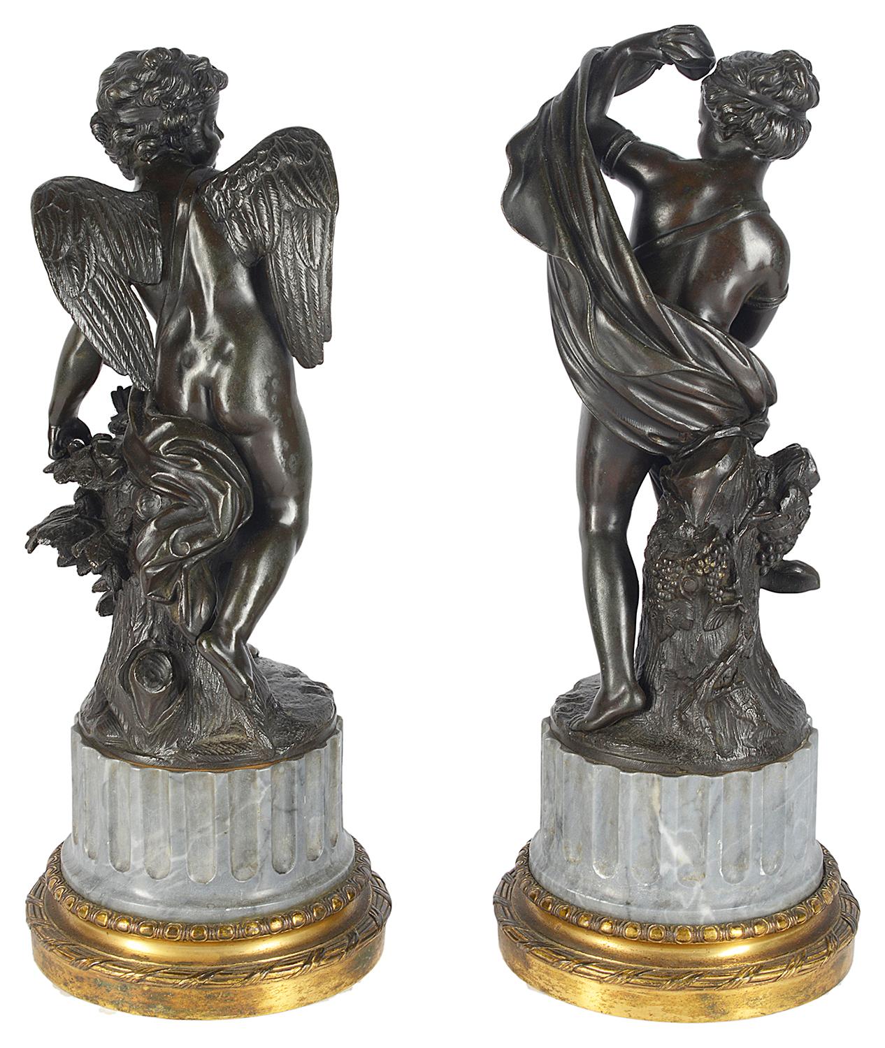 A very good quality pair of classical 19th century bronze statues, depicting a cherub with an arrow and sheath, the other of a semi clad female figure, both mounted on fluted grey marble plinths and gilded ormolu bases.