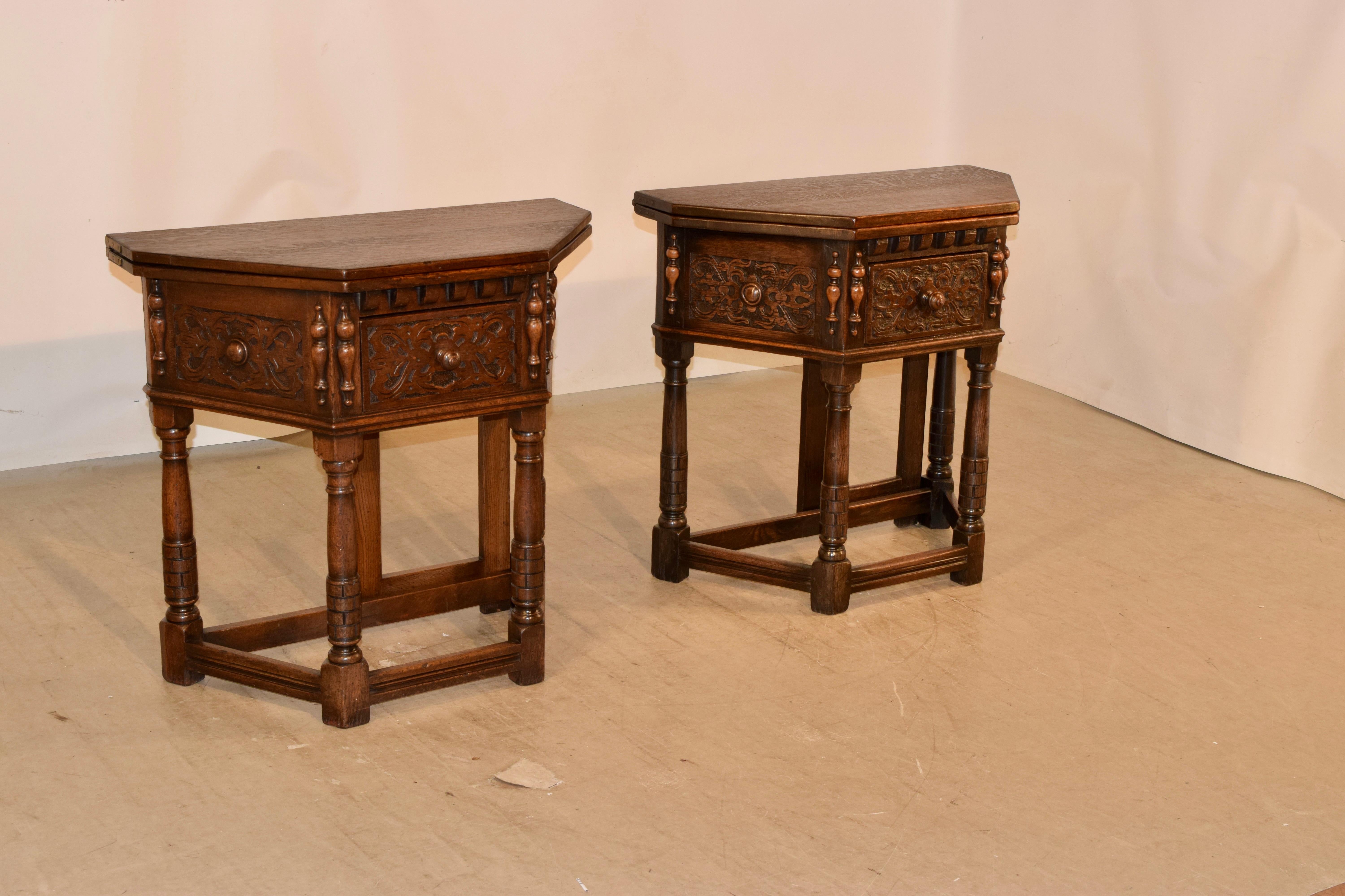 Pair of wonderful 19th century oak console tables from England. The tops are wonderfully grained and open, with he use of a gate leg in the back to an octagonal table top, which is very versatile for any situation. The aprons are heavily hand carved