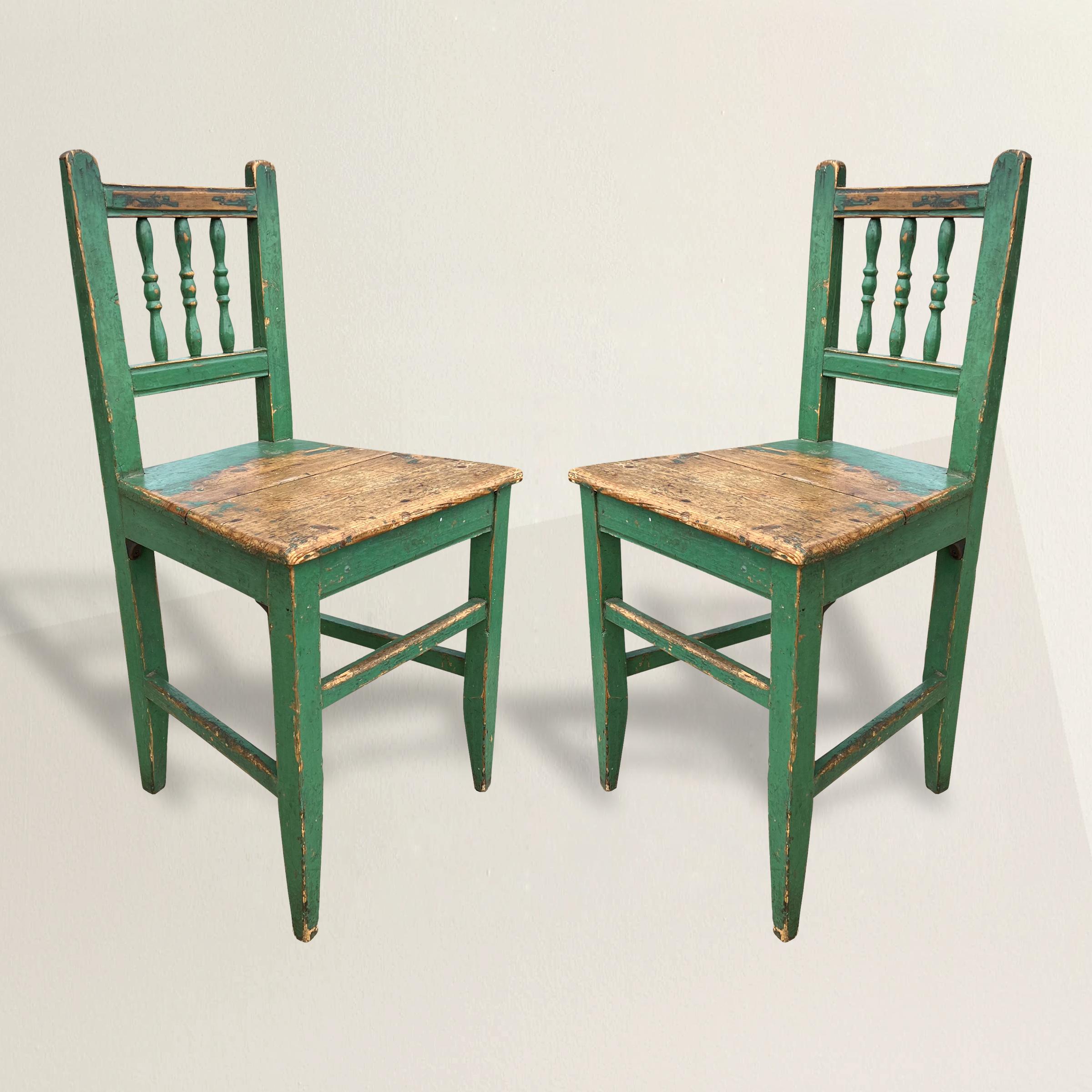 A beautiful pair of 19th century Continental pine farmhouse side chairs with their original green painted finishes and a wonderful patina only time could bestow. The perfect chairs at your breakfast table in your country house, or flanking a console