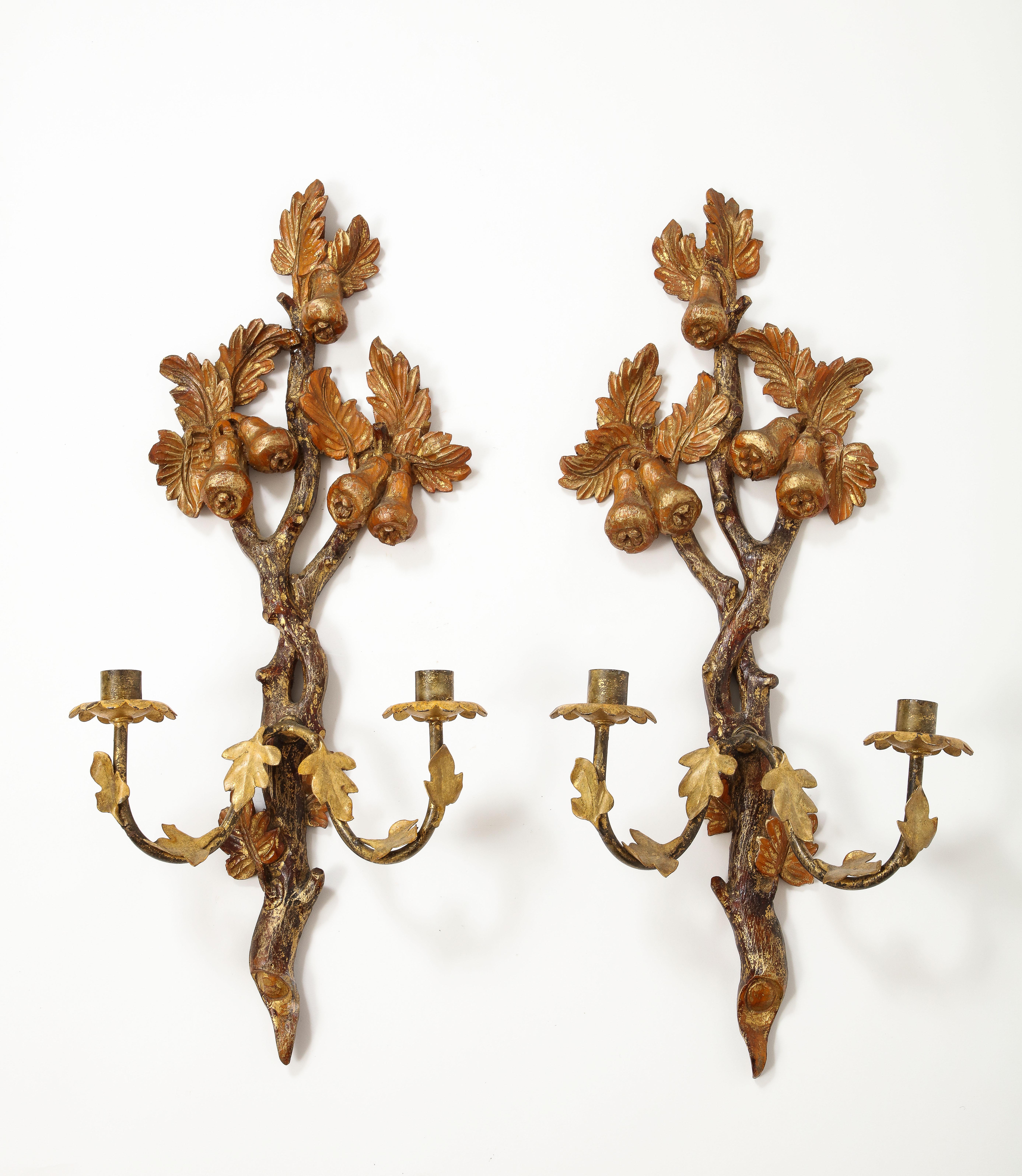 Pair of 19th Century continental hand painted and hand carved wood candle sconces featuring leaves and pears. Beautiful ormolu and gilt condition, in the Empire or Neoclassical style. Each sconce holds two candles. 