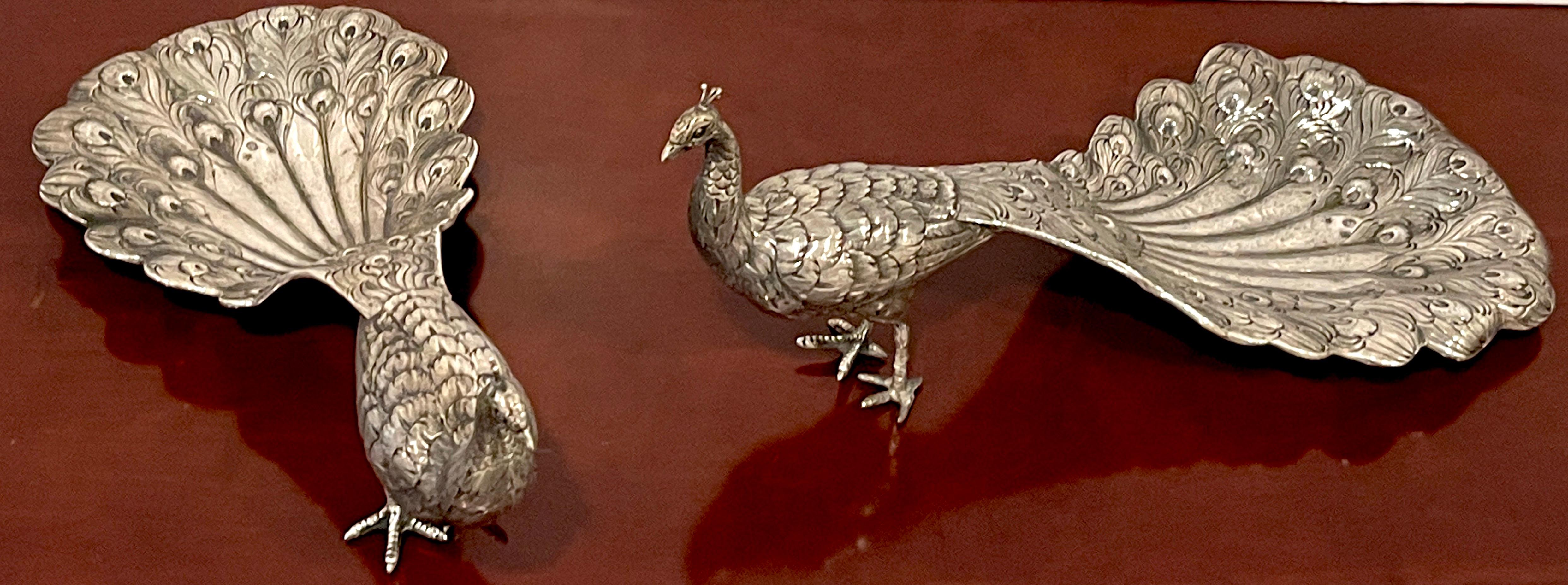 Pair of 19th Century Continental silver table figures of peacocks 
Germany, Circa 1880s
Each one realistically cast, modeled and chased figures/models of standing peacocks. These whimsical sculptures can be used as table ornaments or as serving