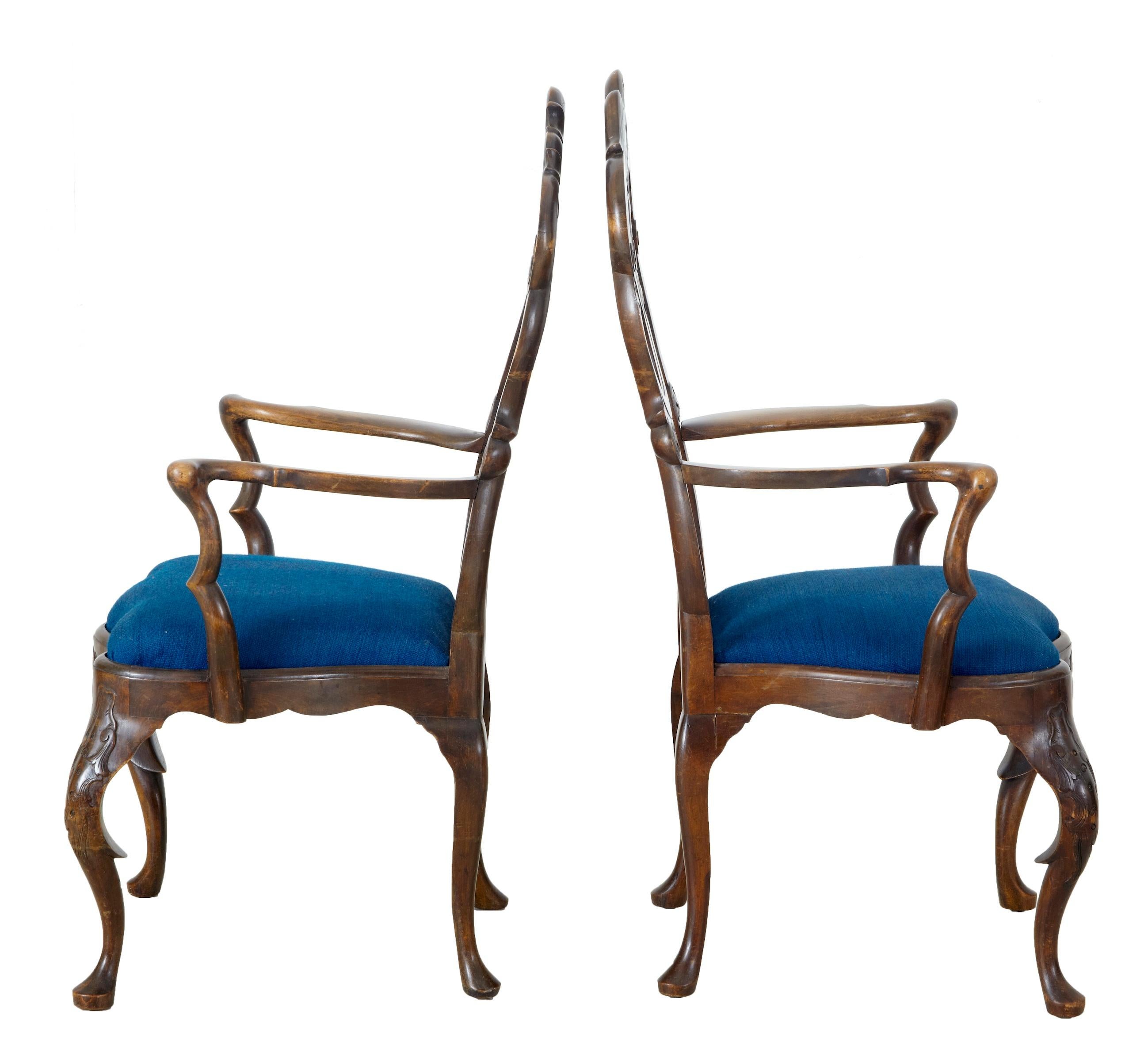 Fine pair of carved armchairs, possibly Dutch, circa 1820.
Beautifully joined swags and carved back, with a small heart formed in the lower section.
Shaped elbow arms, leading down to the later upholstered drop in seat.
Carved front apron, with