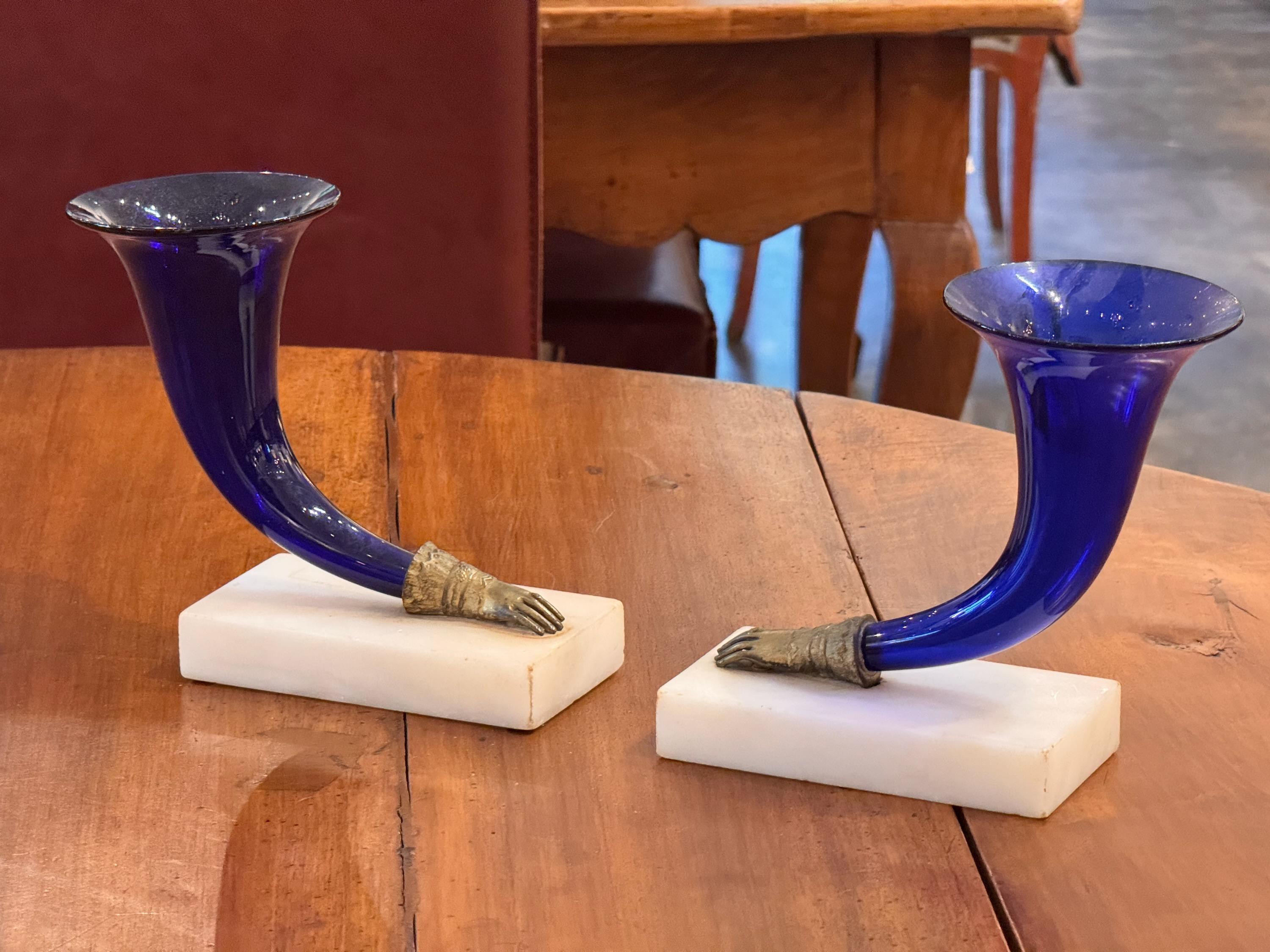 This is a beautiful pair of Colbalt blue glass hand vases. Perfect for the mantle.