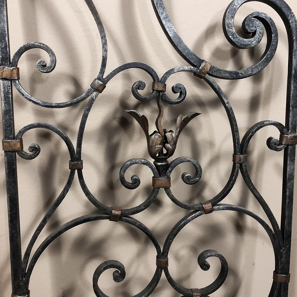 Pair of 19th century Country French wrought iron garden gates are perfect for accenting your garden, or for providing unique eye appeal indoors! Exquisitely hand-forged into intricate scrollwork patterns accented by forged acanthus plumes that are