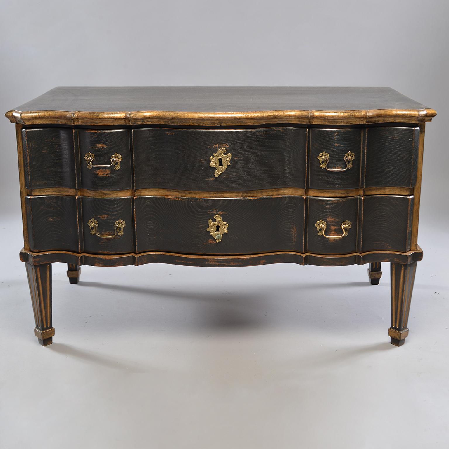 Pair of Danish oak chests feature two drawers each, serpentine fronts, reeded legs, brass hardware, black painted and gilded finish, circa 1880s. Unknown maker. Sold and priced as a pair.