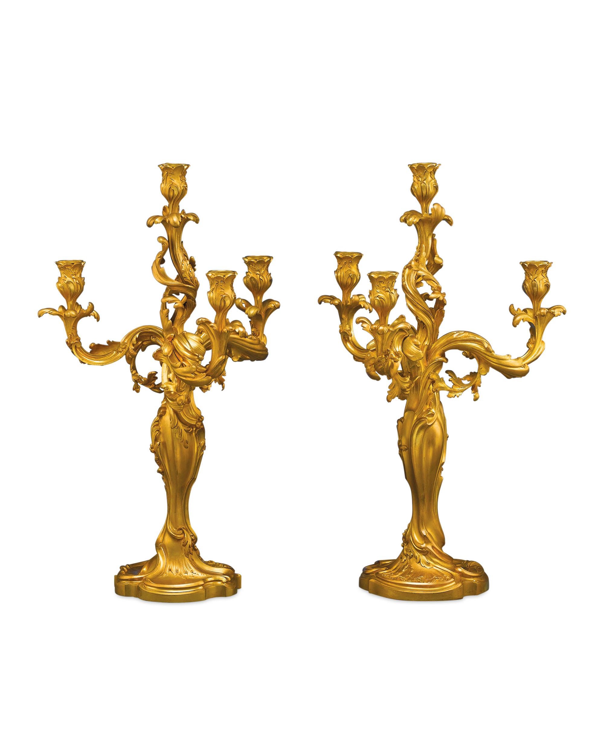 An exceptional pair of hand-chased doré bronze candelabra by the distinguished French sculptor Eugène Lelièvre, and foundered by Susse Freres of Paris. Influenced by the designs of Meissonier, flowing lines and graceful form of the Art Nouveau are