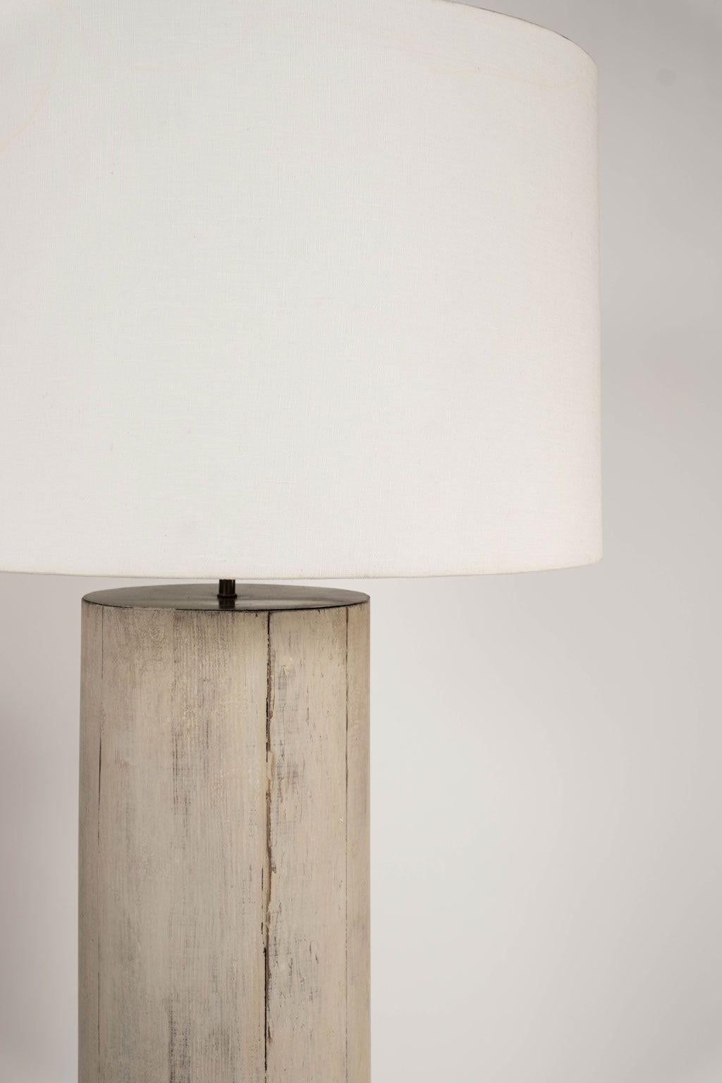 Pair of 19th century Doric column floor lamps from France. Remnants of layers of paint. Newly wired for use within the USA. Includes linen drum shades. Sold together and priced $9,700 for the pair.