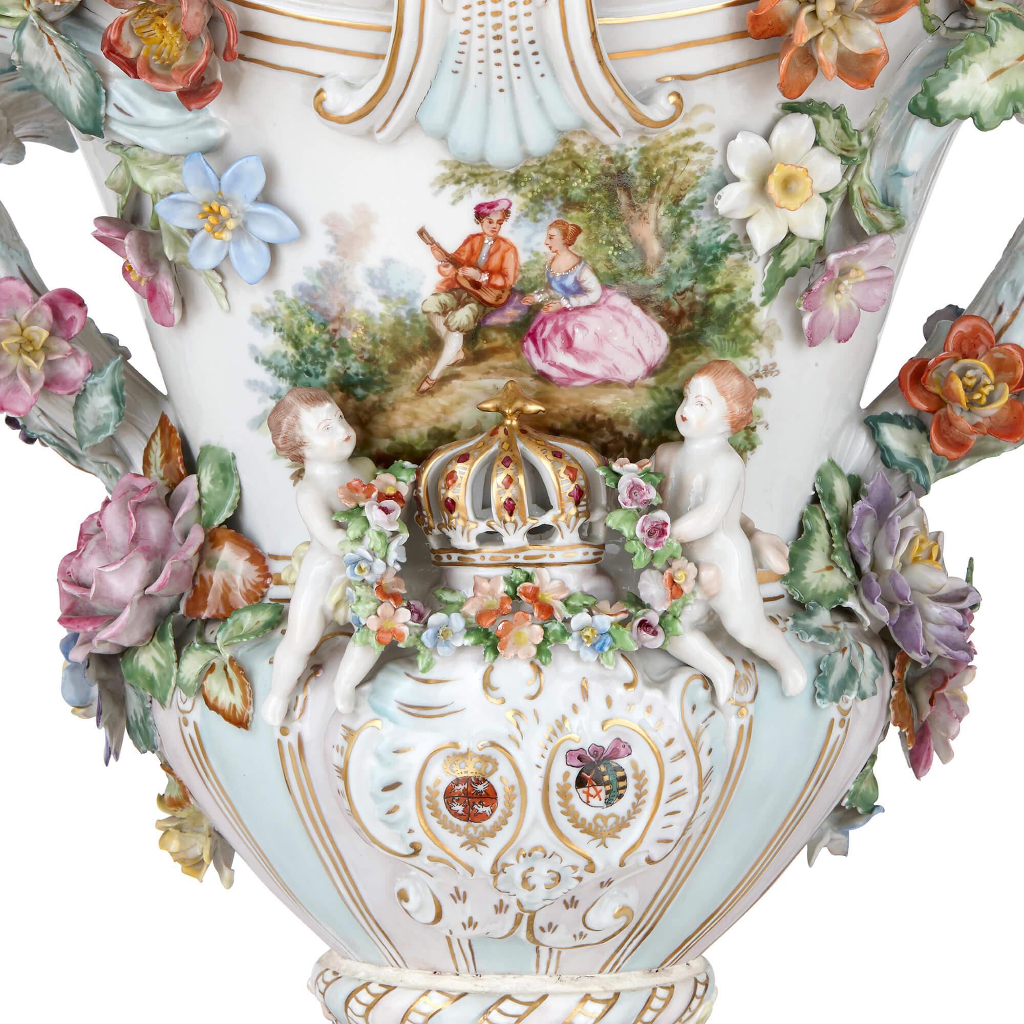 These wonderful Dresden porcelain vases are exceptional examples of the organic forms, natural subject matter and charming flamboyance of the German Rococo. Each vase displays a stunning array of applied porcelain flowers on its exterior, arranged